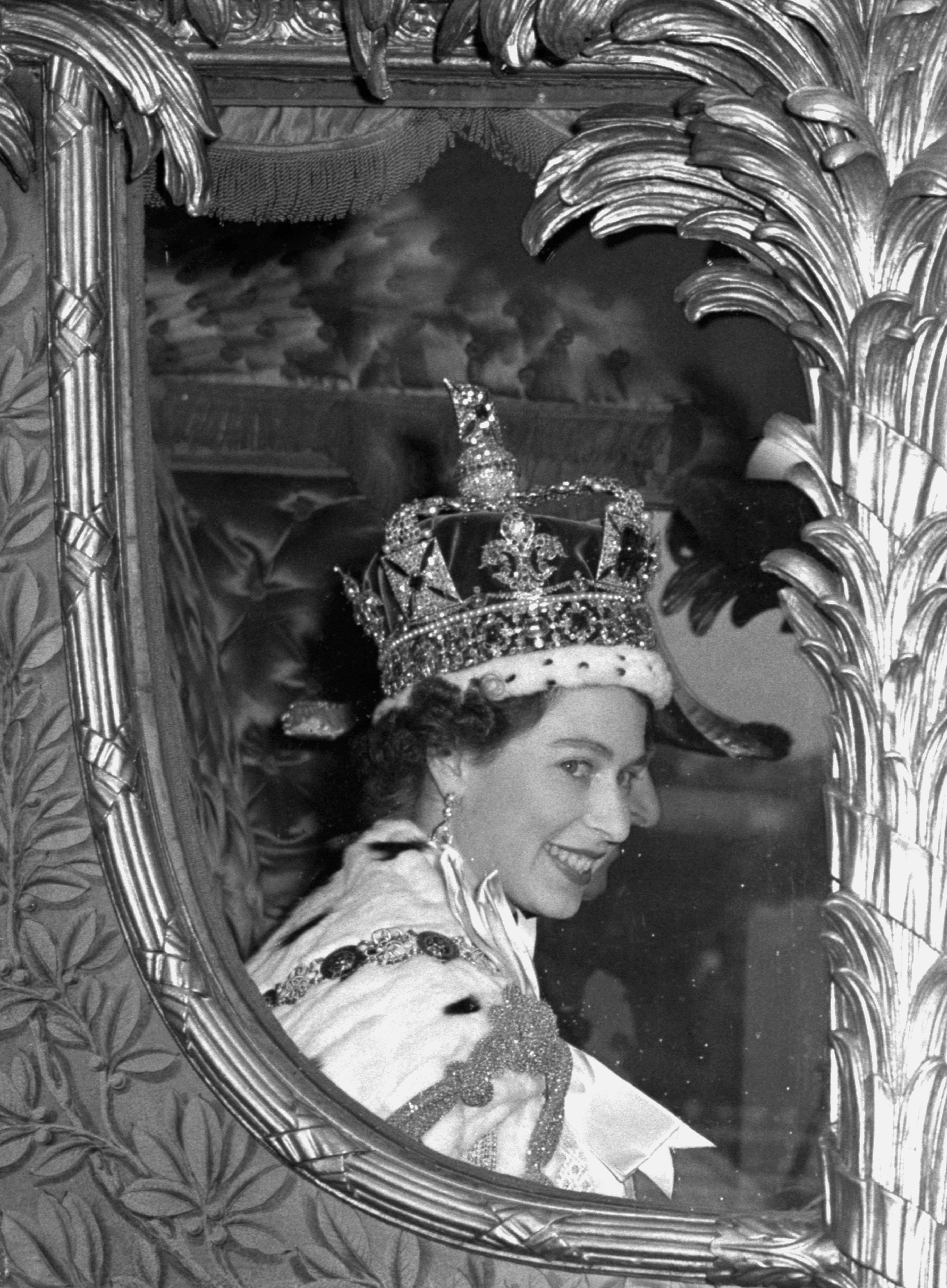 The Queen gives a wide smile for the crowd from her carriage as she leaves Westminster Abbey, London, after her Coronation (PA)