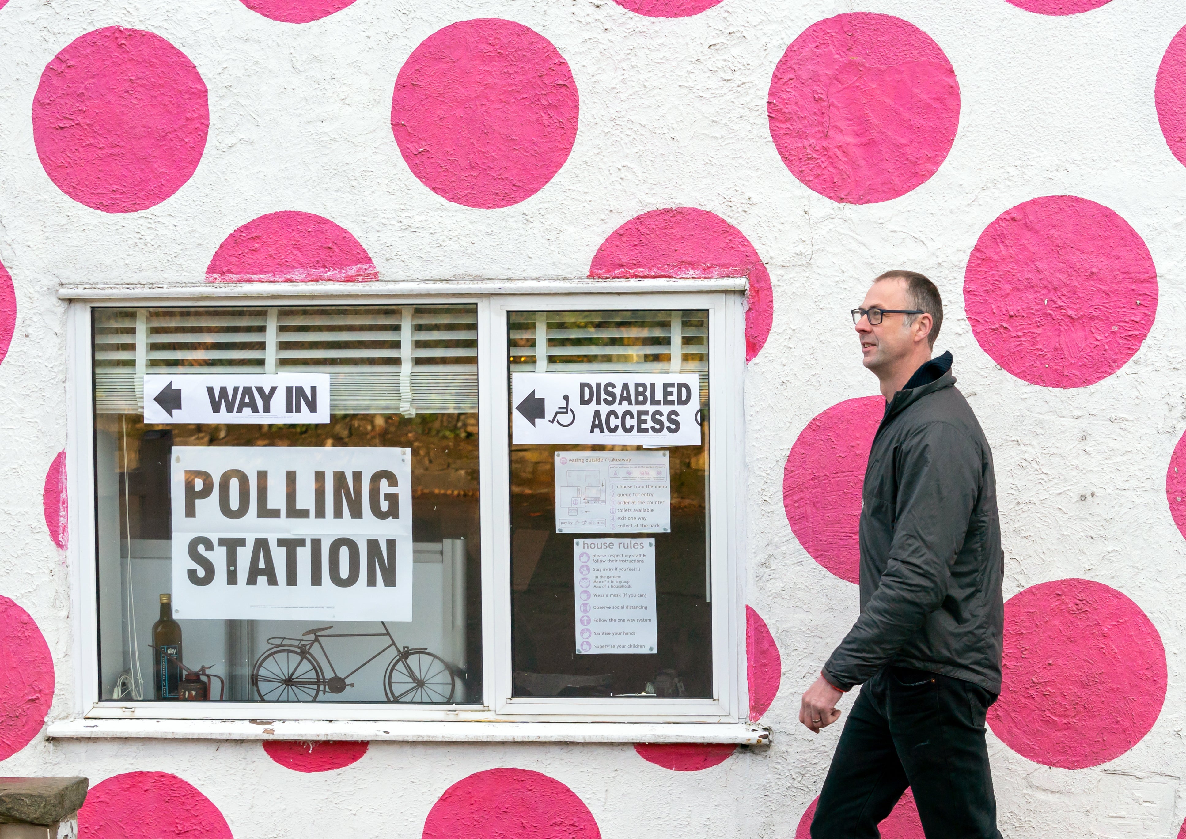 A man walks past a polling station in the Bank View Cafe, Sheffield (Danny Lawson/PA)