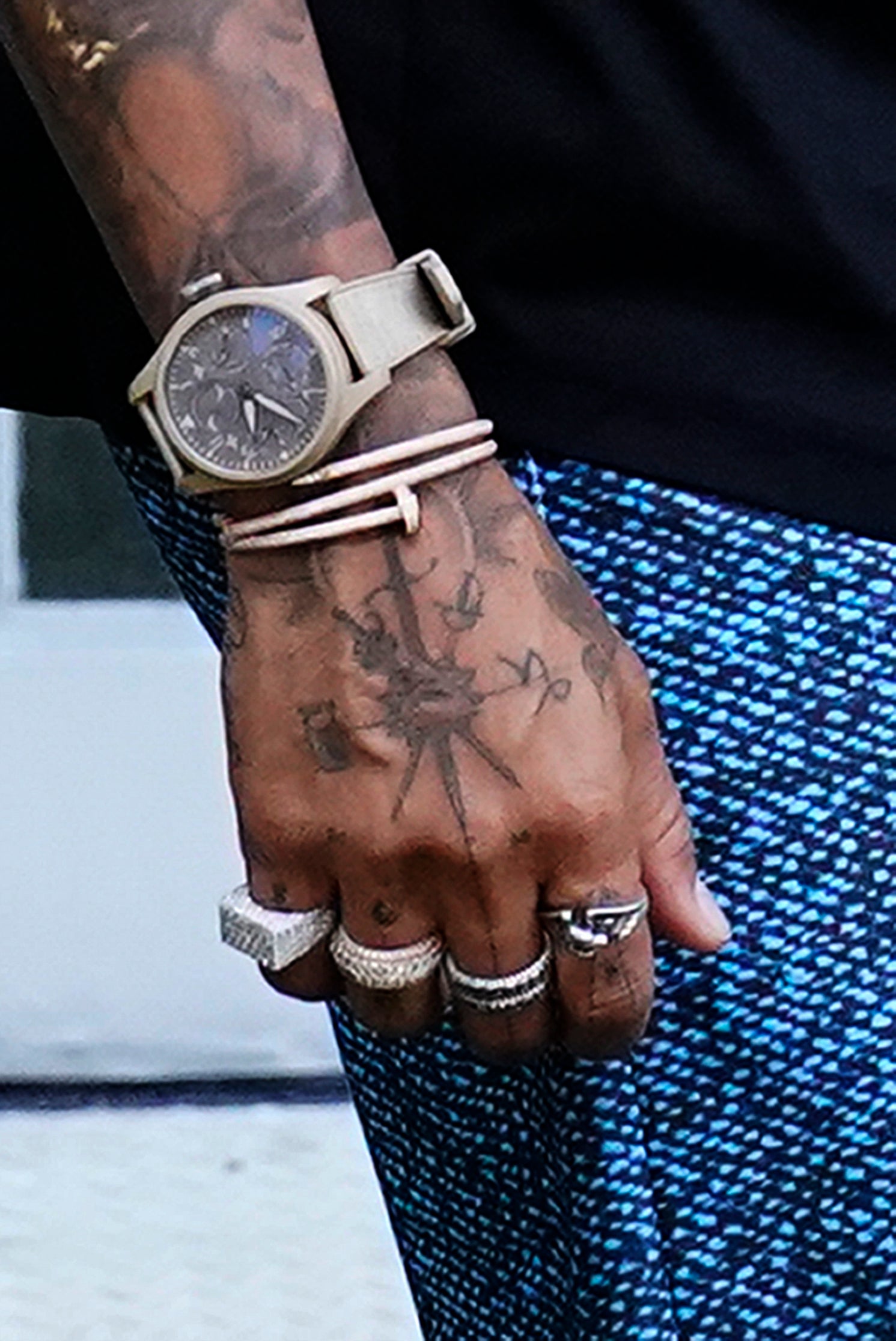 Lewis Hamilton arrives for first practice wearing multiple rings, watches and bracelets (Wilfredo Lee/AP)