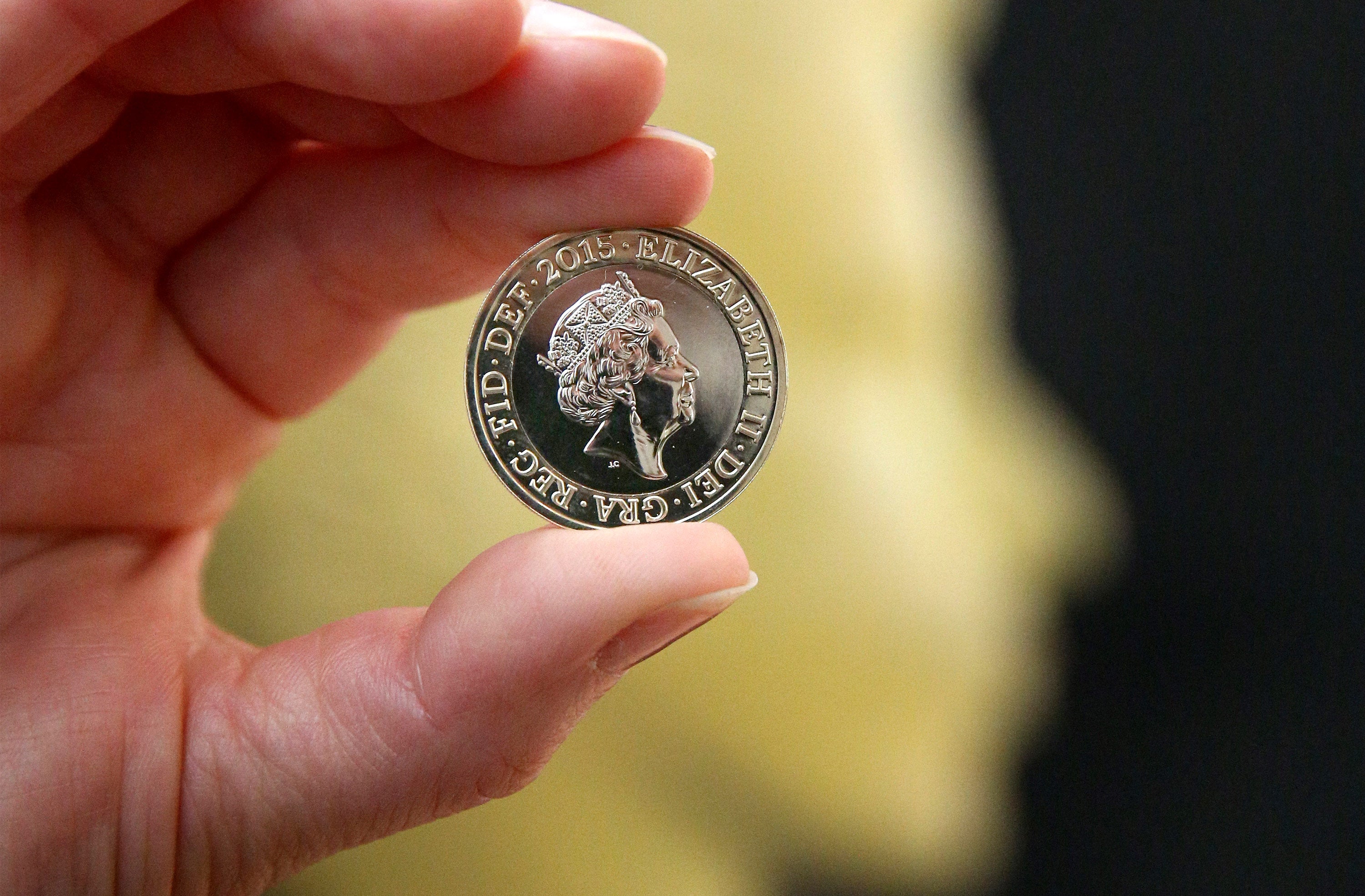 A two pound coin featuring a new portrait of Queen Elizabeth II is displayed at The National Portrait Gallery on March 2, 2015