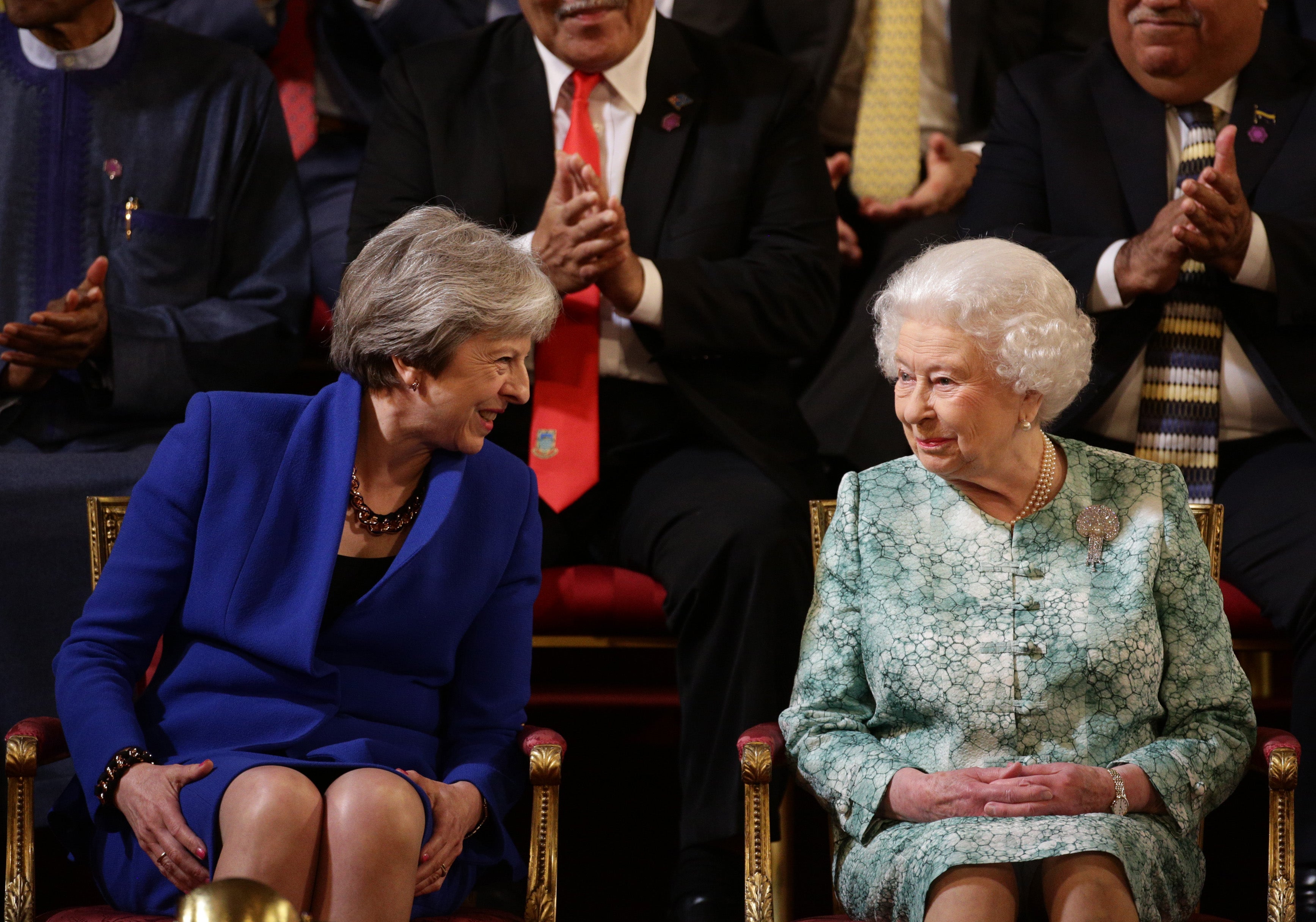 Theresa May sits with Queen Elizabeth on April 19, 2018