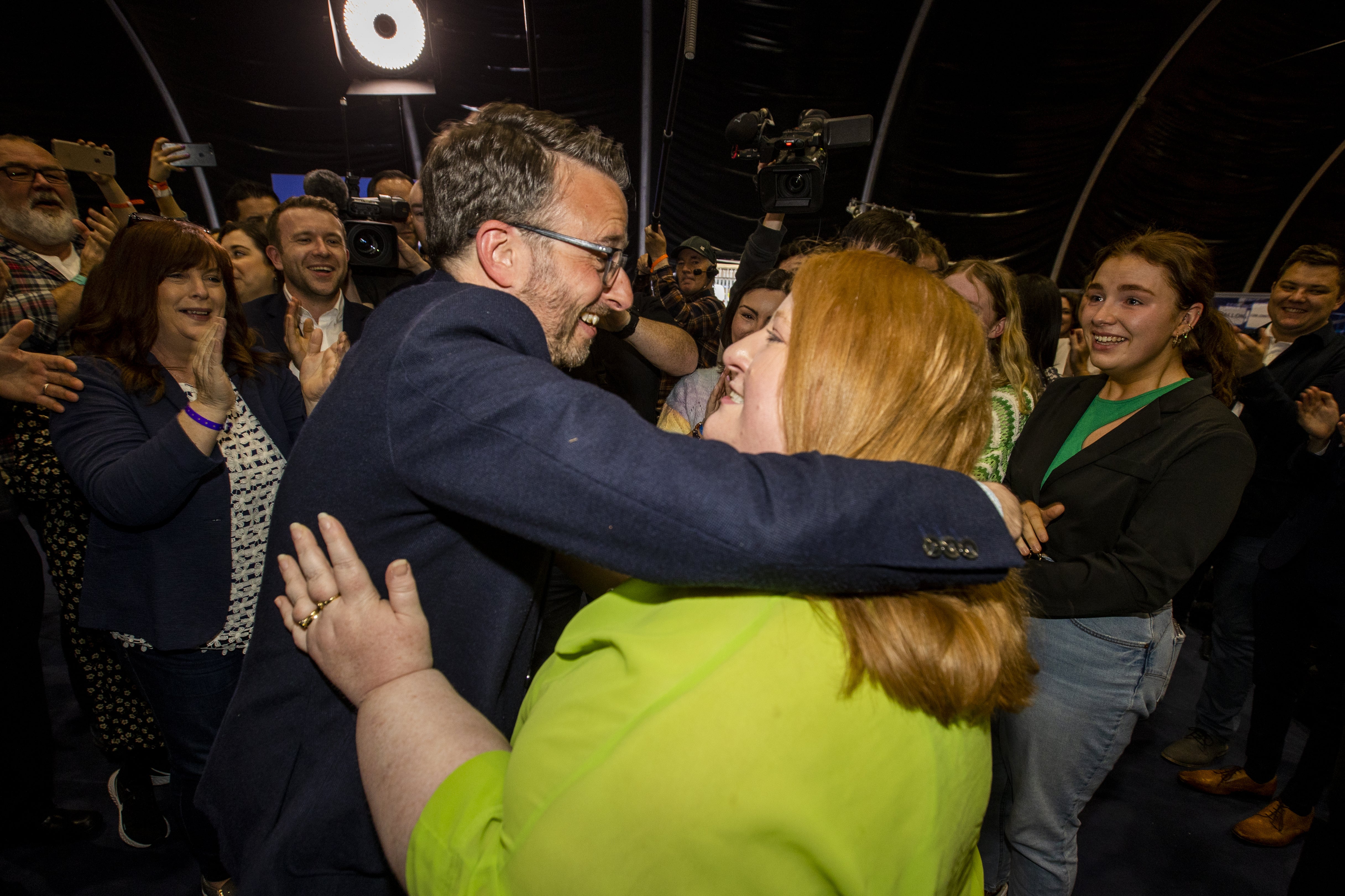 Alliance Party leader Naomi Long celebrates with her newly-elected party colleague Nick Mathison (Liam McBurney/PA)