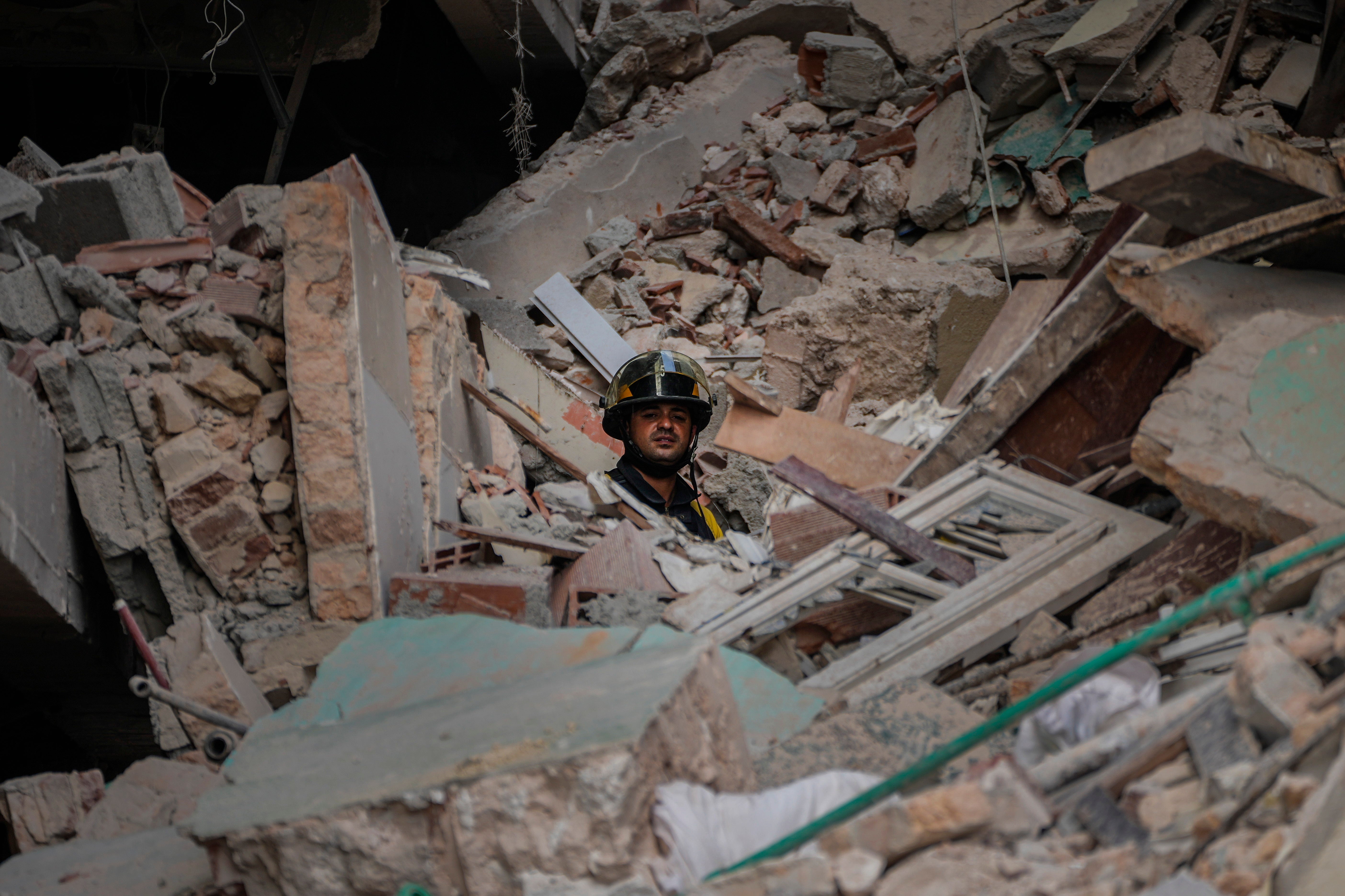 A rescuer looks out from the site of Friday's deadly explosion that destroyed the five-star Hotel Saratoga during a search for survivors