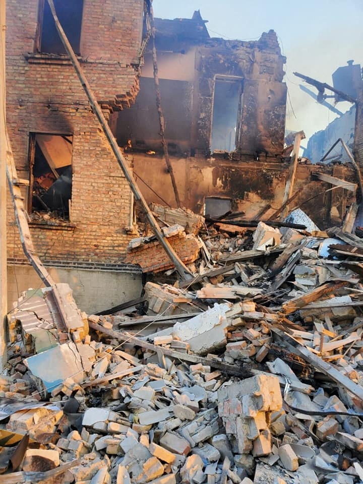 Debris next to a partially collapsed building is seen after a school building was hit