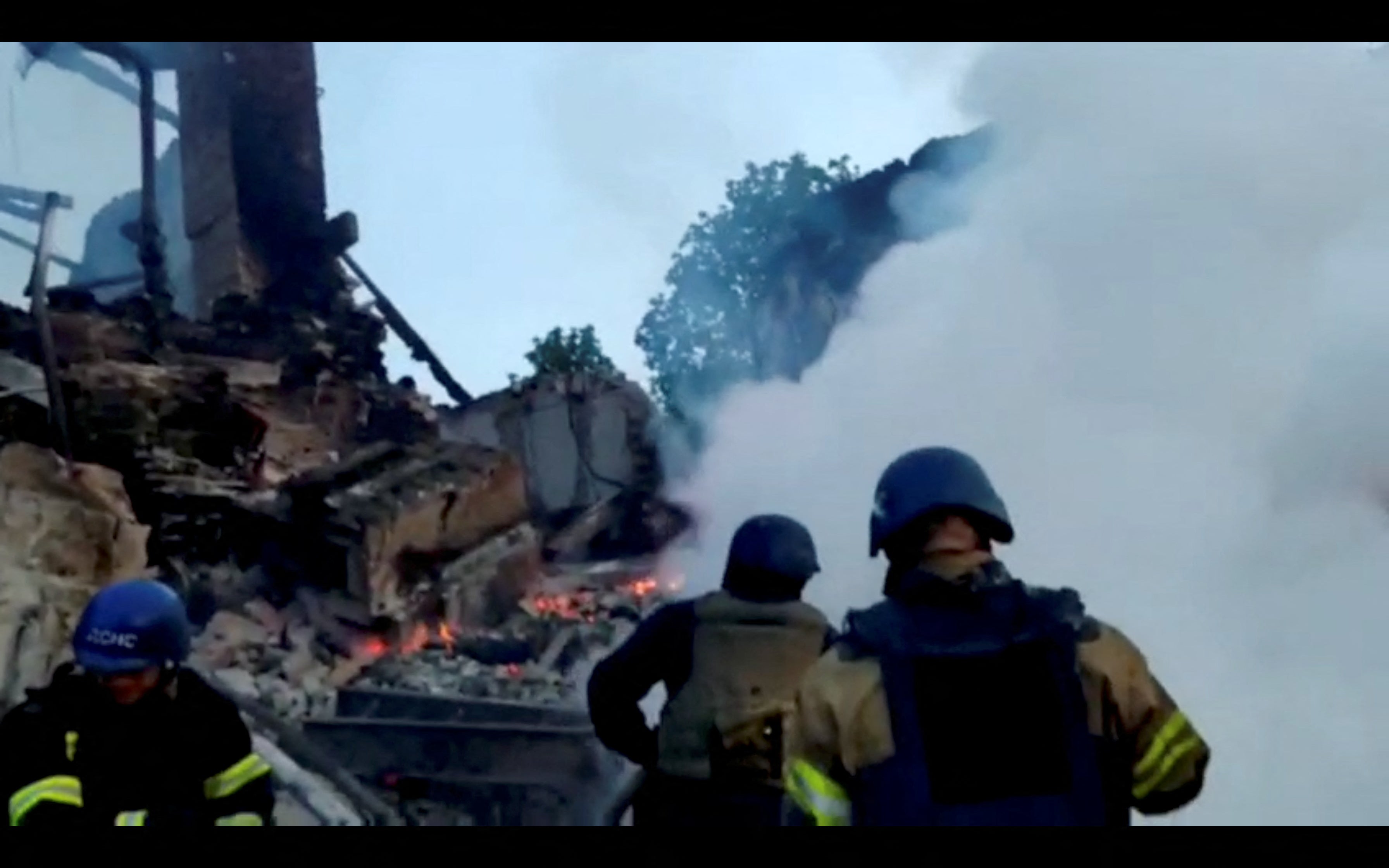 Burning debris is seen after a school building was hit