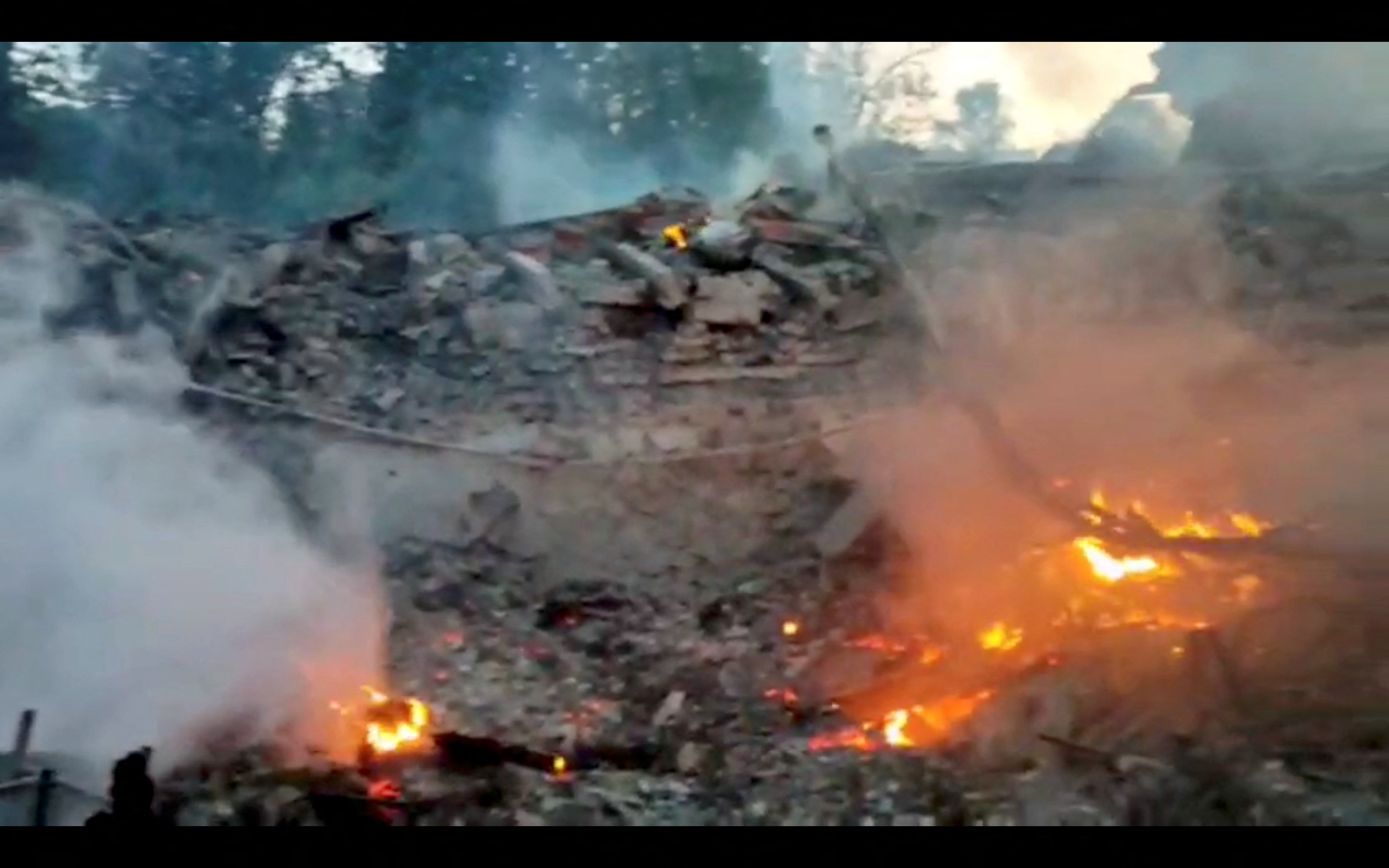 Burning debris is seen in the village of Bilohorivka