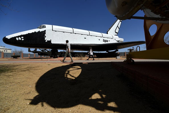 People walk close to one of the Soviet era space shuttles Buran installed in a museum at Russian-leased Baikonur Cosmodrome in Kazakhstan