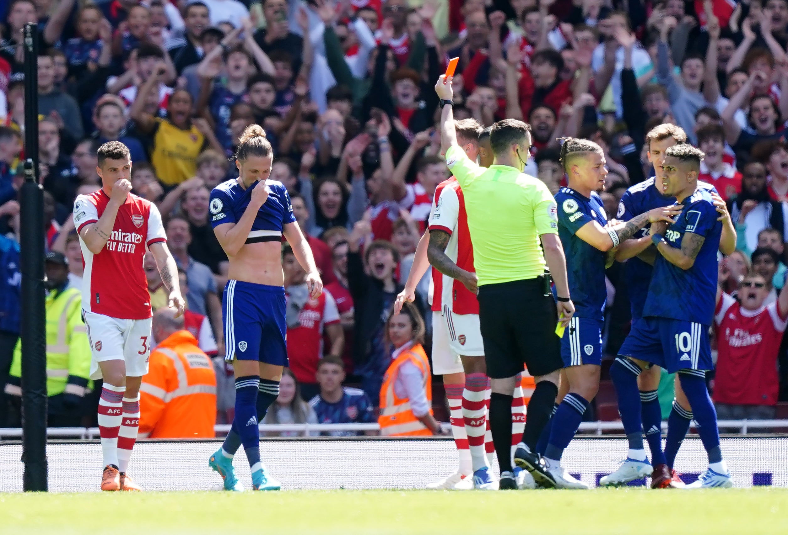 Referee Chris Kavanagh shows a red card to Luke Ayling (Mike Egerton/PA)