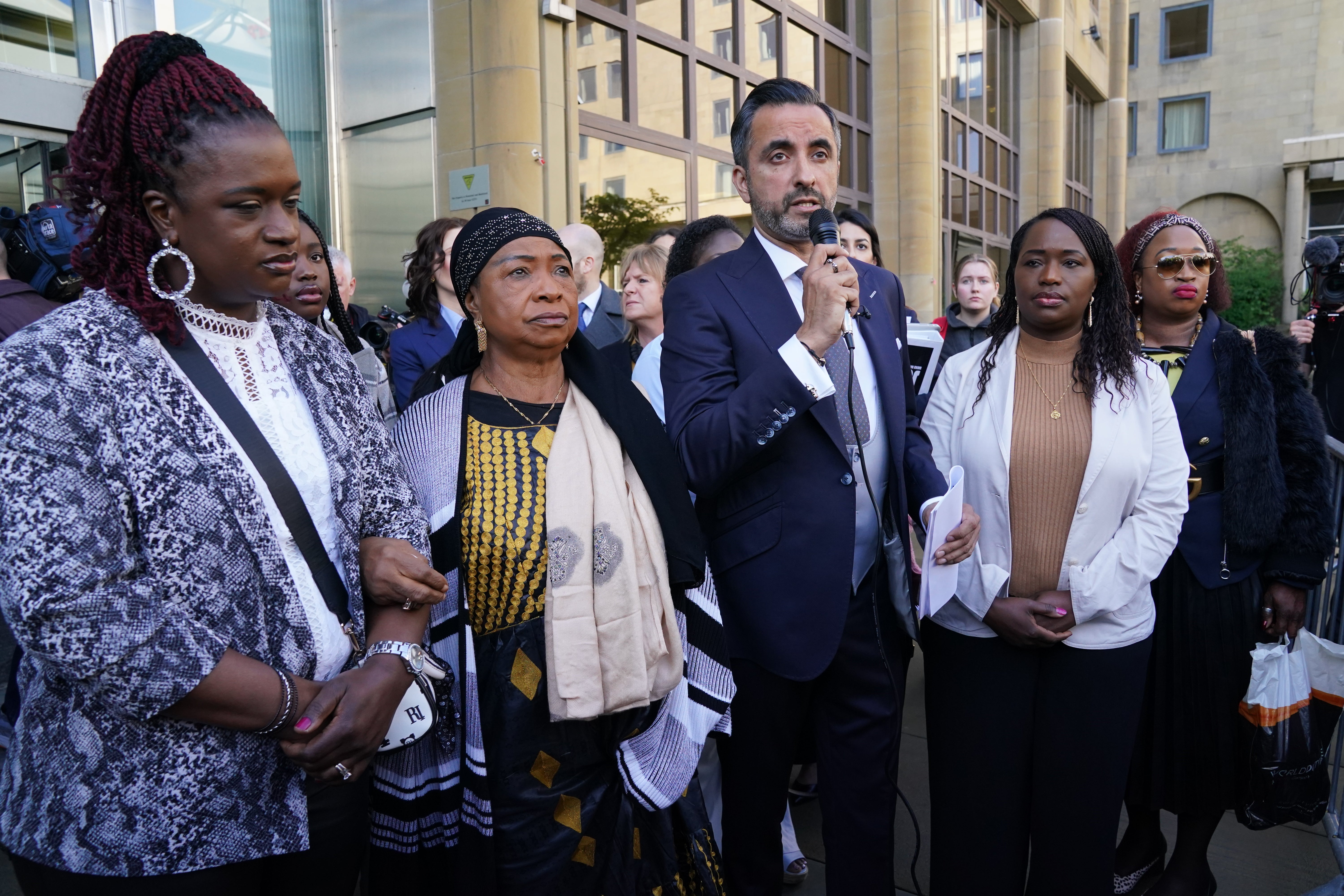 Sheku’s mother Aminata Bayoh (second left) with Sheku’s sisters and lawyer Aamer Anwar (centre) at the start of a public inquiry into the death of Sheku Bayoh