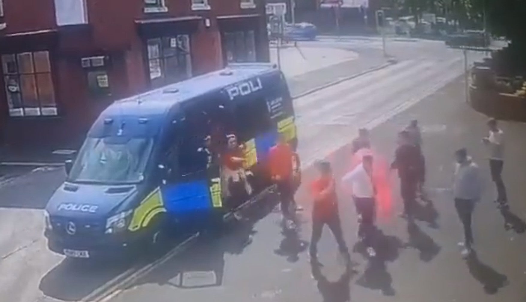 Fans head out of the police van and towards the pub