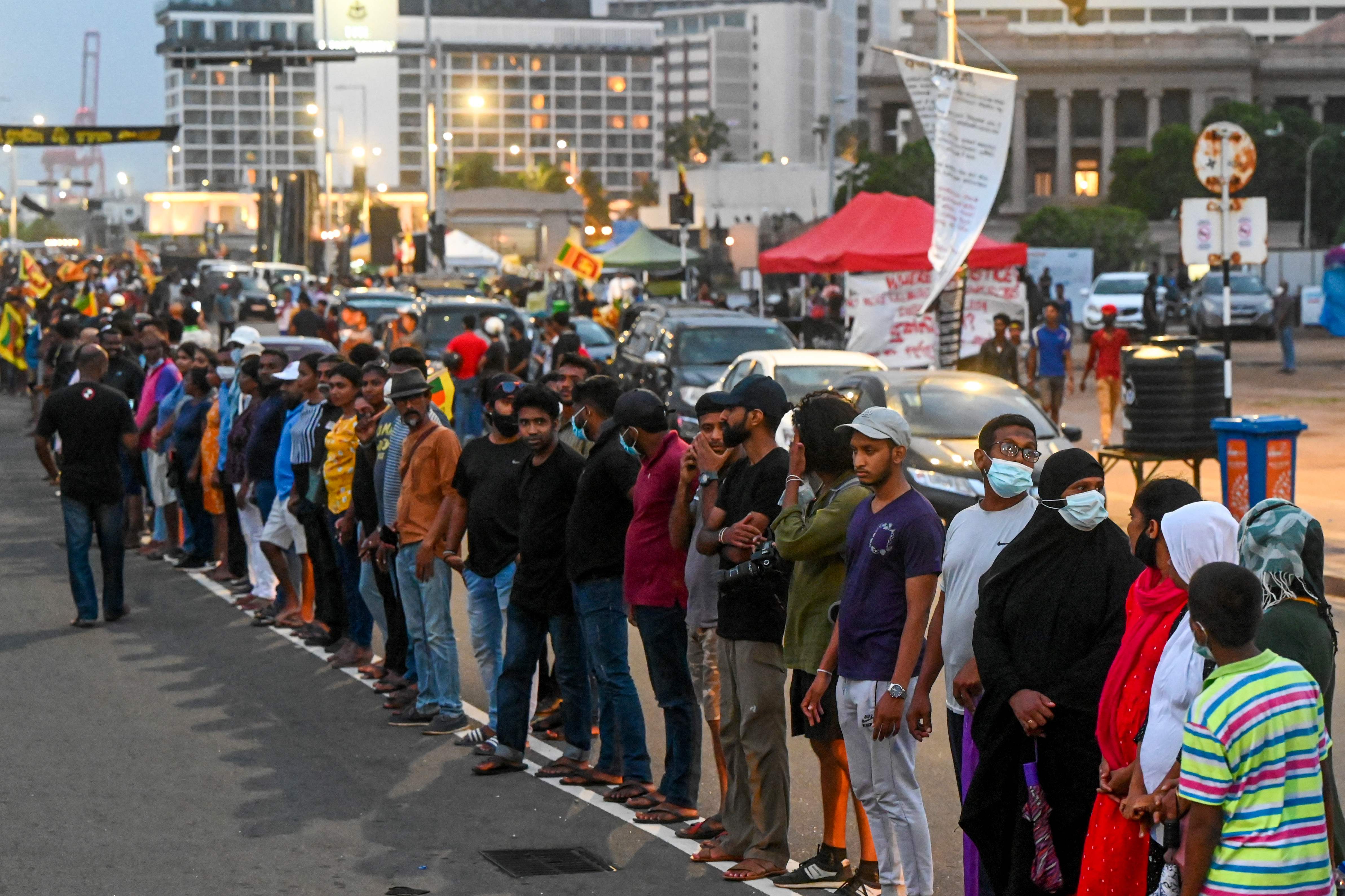 Anti-government demonstrators take part in a protest near the president's office in Colombo on Tuesday