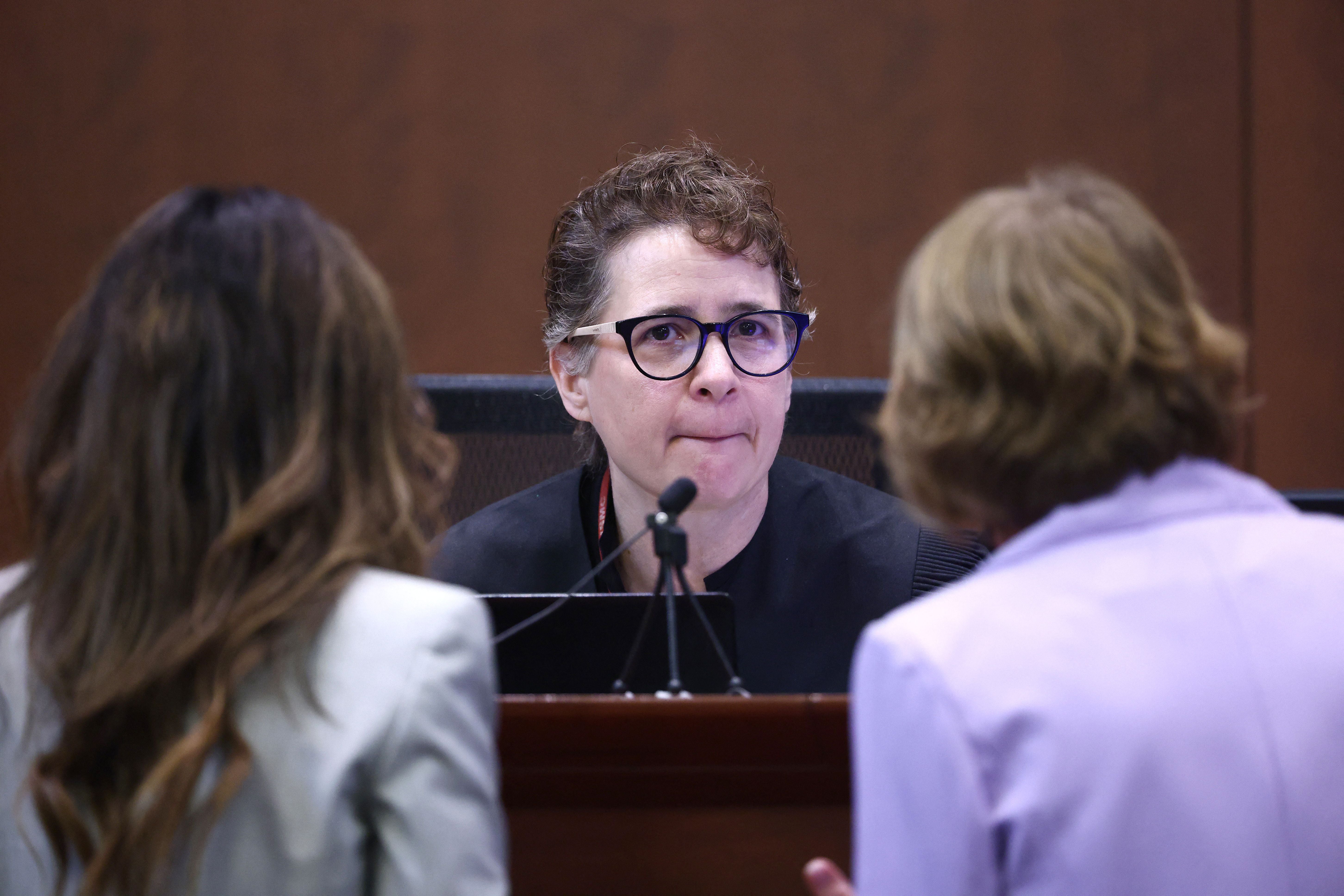 Judge Penney Azcarate (center) speaks with attorneys at the Fairfax County Courthouse in Fairfax, Virginia, on 5 May 2022