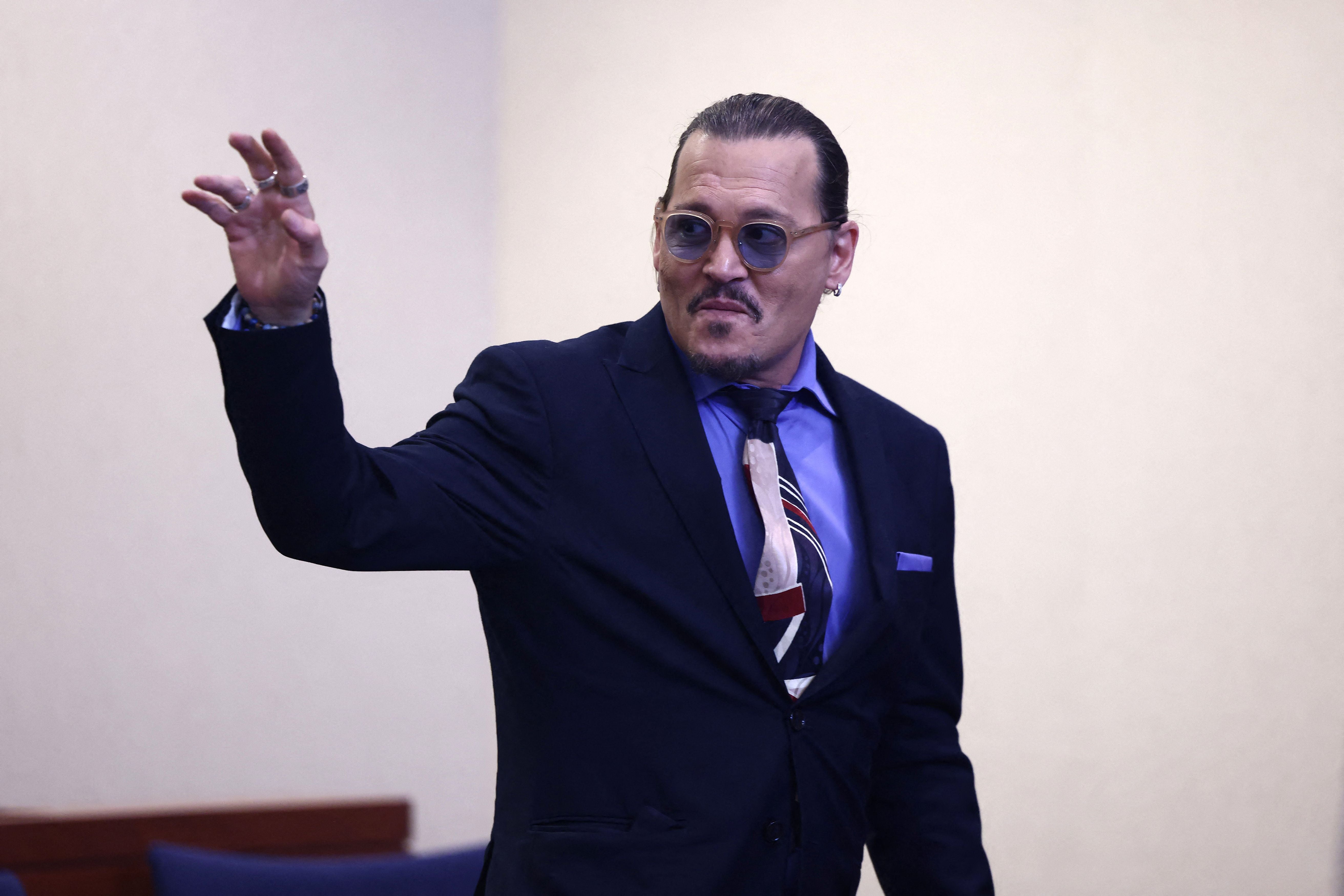 Johnny Depp waves as he departs the Fairfax County Courthouse in Fairfax, Virginia, on 5 May 2022