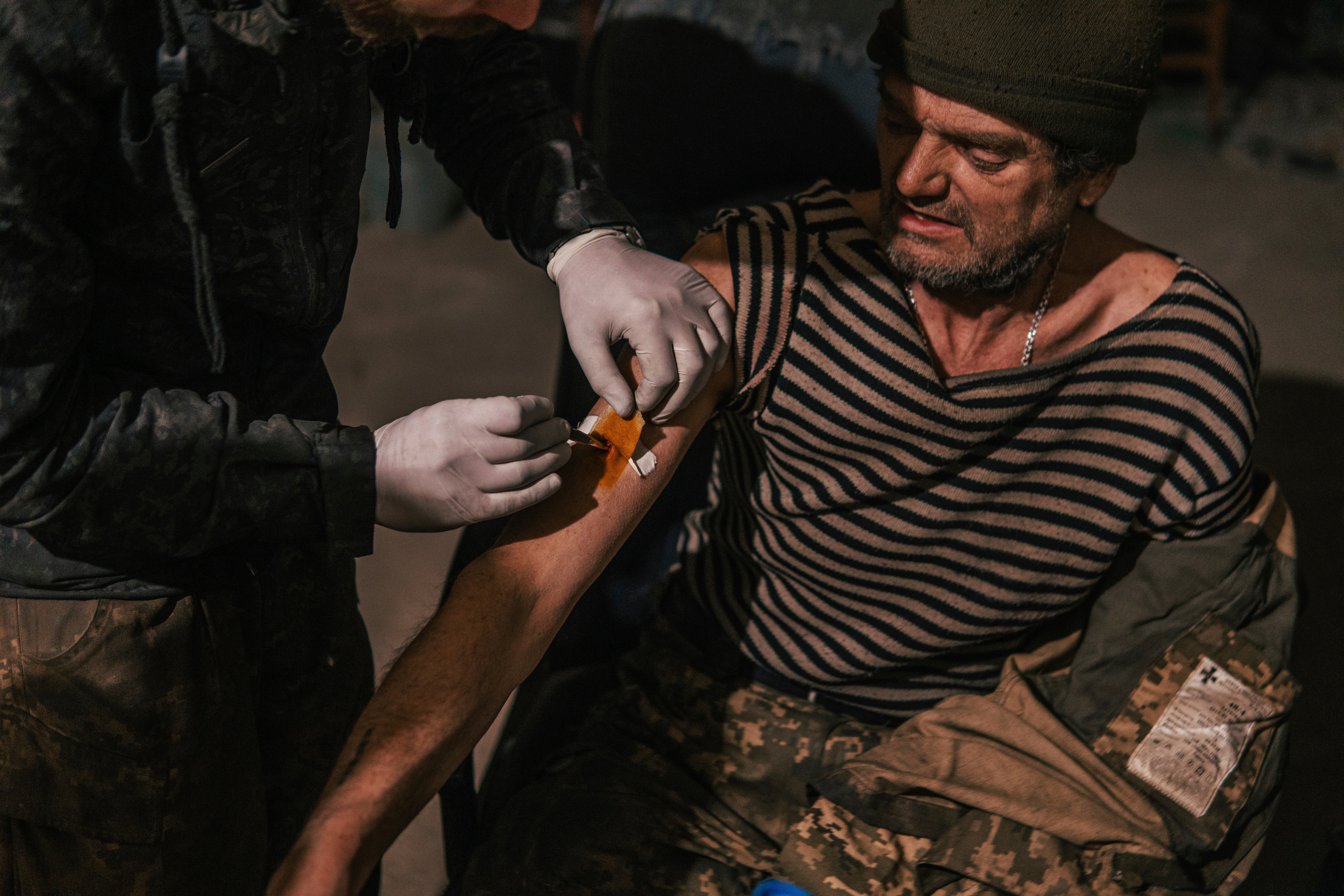 In this photo provided by Azov Special Forces Regiment of the Ukrainian National Guard Press Office, an Azov Special Forces Regiment's serviceman receives treatment inside the Azovstal steel plant in Mariupol, Ukraine, Tuesday, May 10, 2022