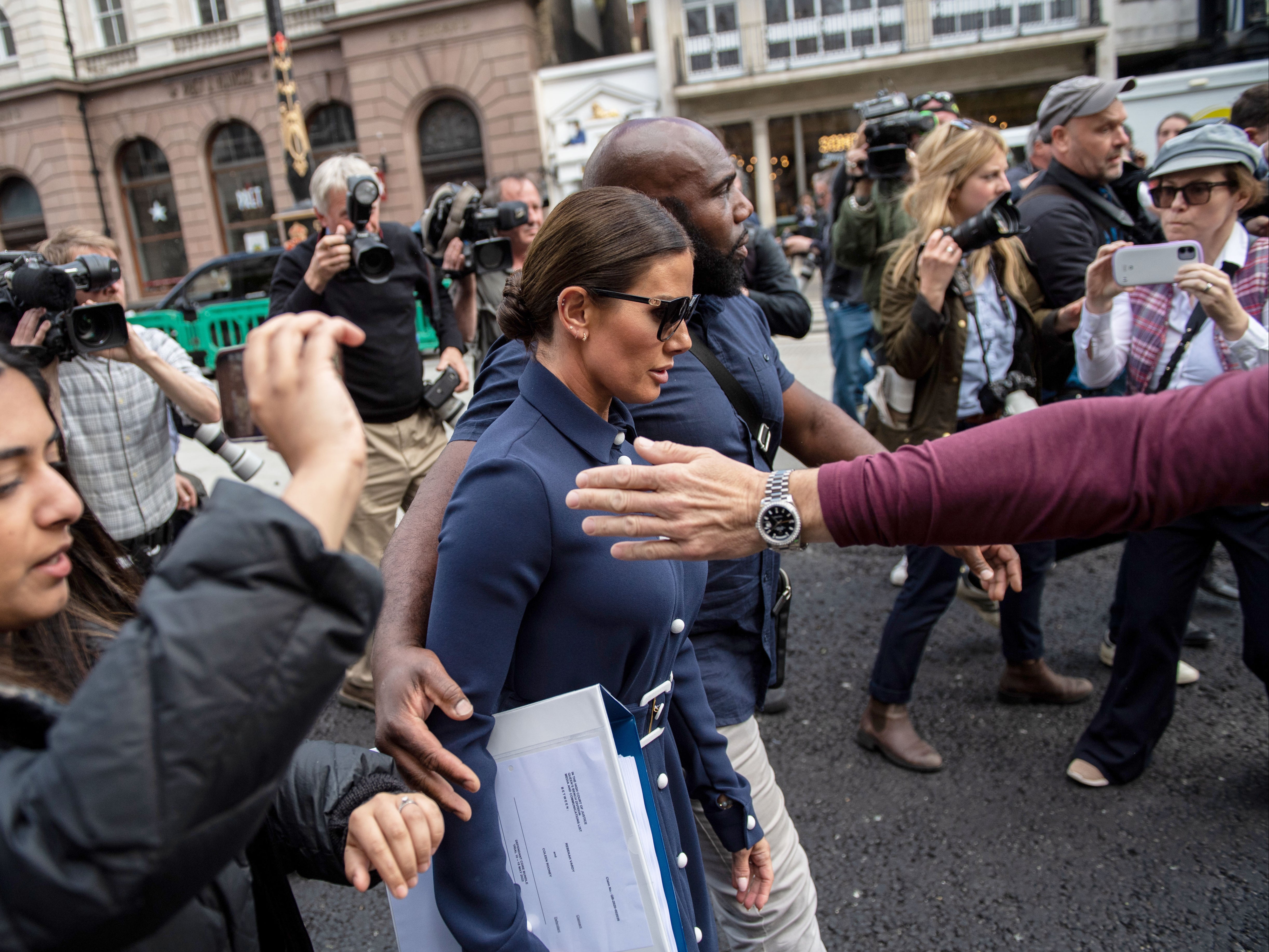 Members of the press photograph and film Rebekah Vardy leaving the Royal Courts of Justice on Tuesday