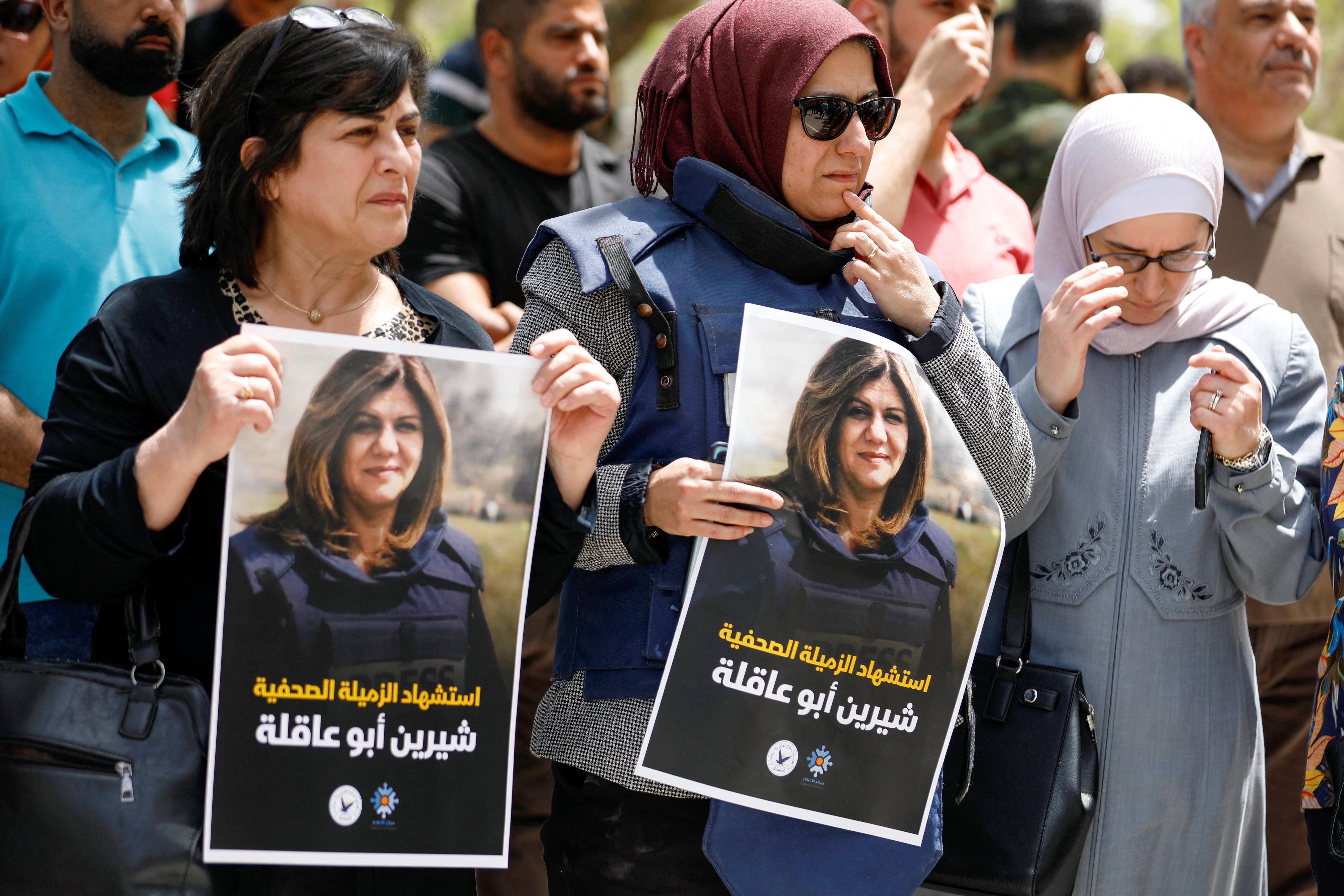 Palestinians hold pictures of Al Jazeera reporter Shireen Abu Akleh, who was killed by Israeli army gunfire during an Israeli raid, according to the Qatar-based news channel, in the West Bank