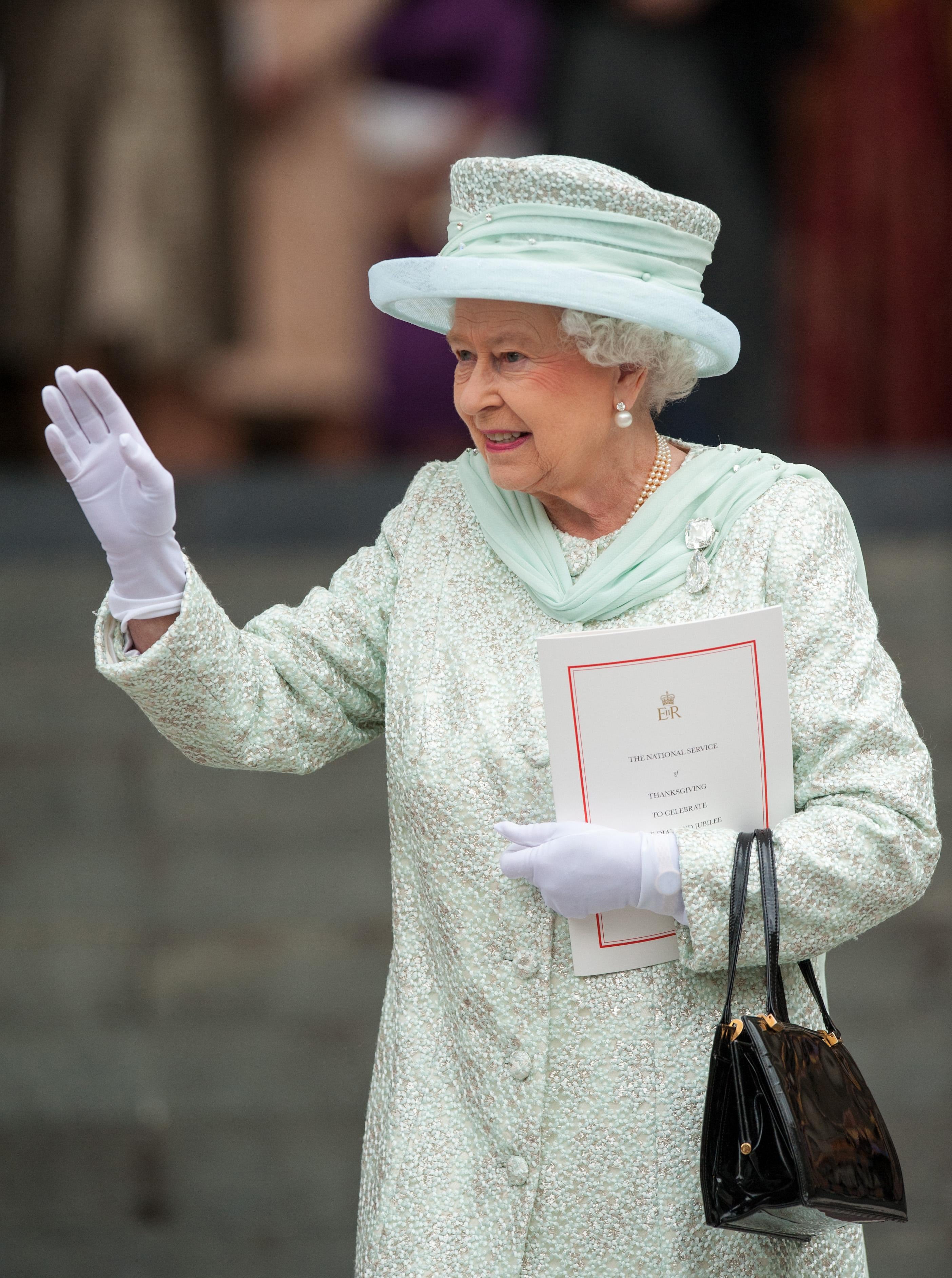 The Queen waves to the crowds following the service of thanksgiving for her Diamond Jubilee (Dominic Lipinski/PA)