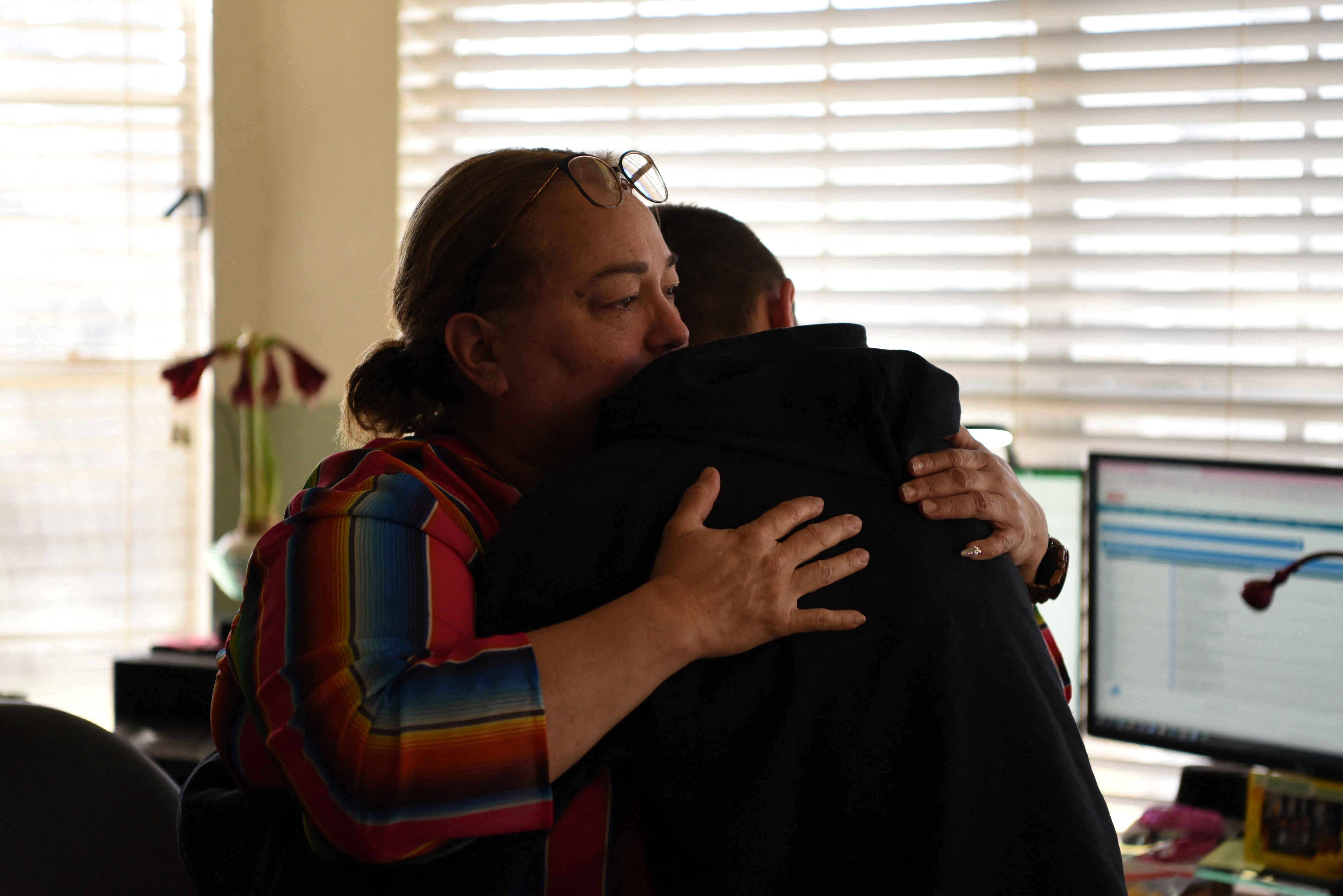 Margaret Garza hugs her son Julius Garza in Converse, Texas