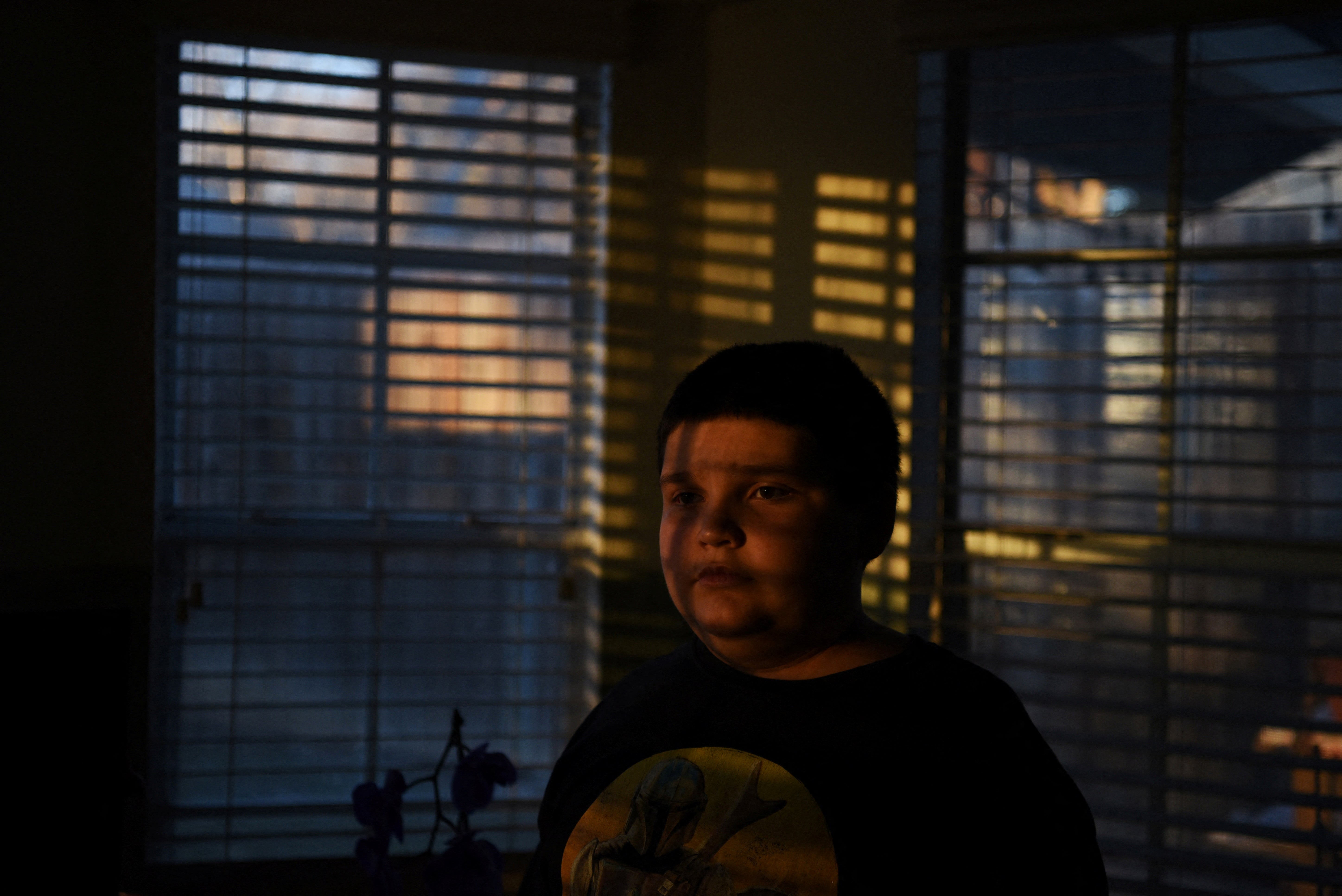 Aidan Garza poses for a portrait at home