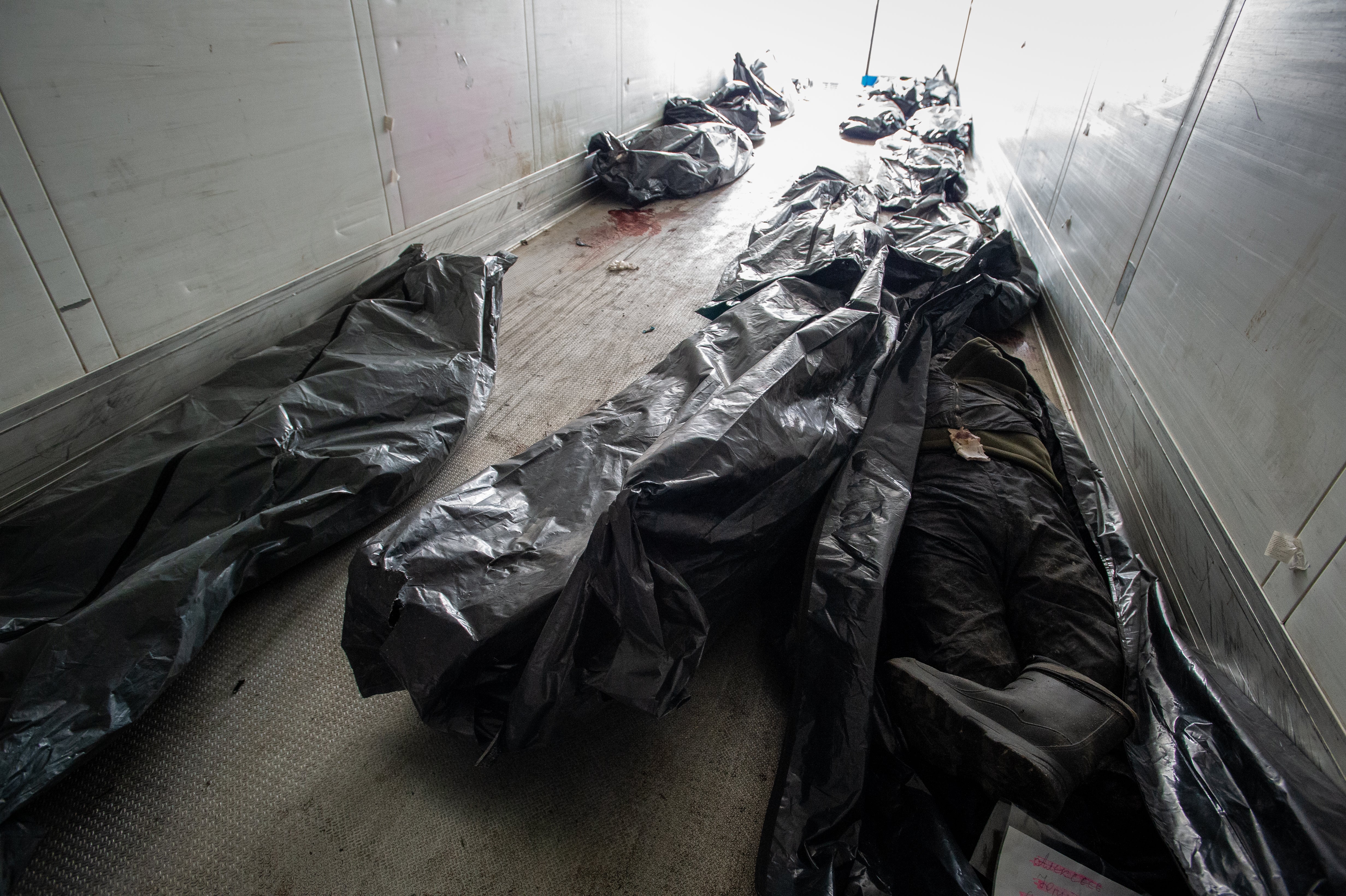 More than a dozen bodybags wait for collection in a refrigerated lorry, Bucha