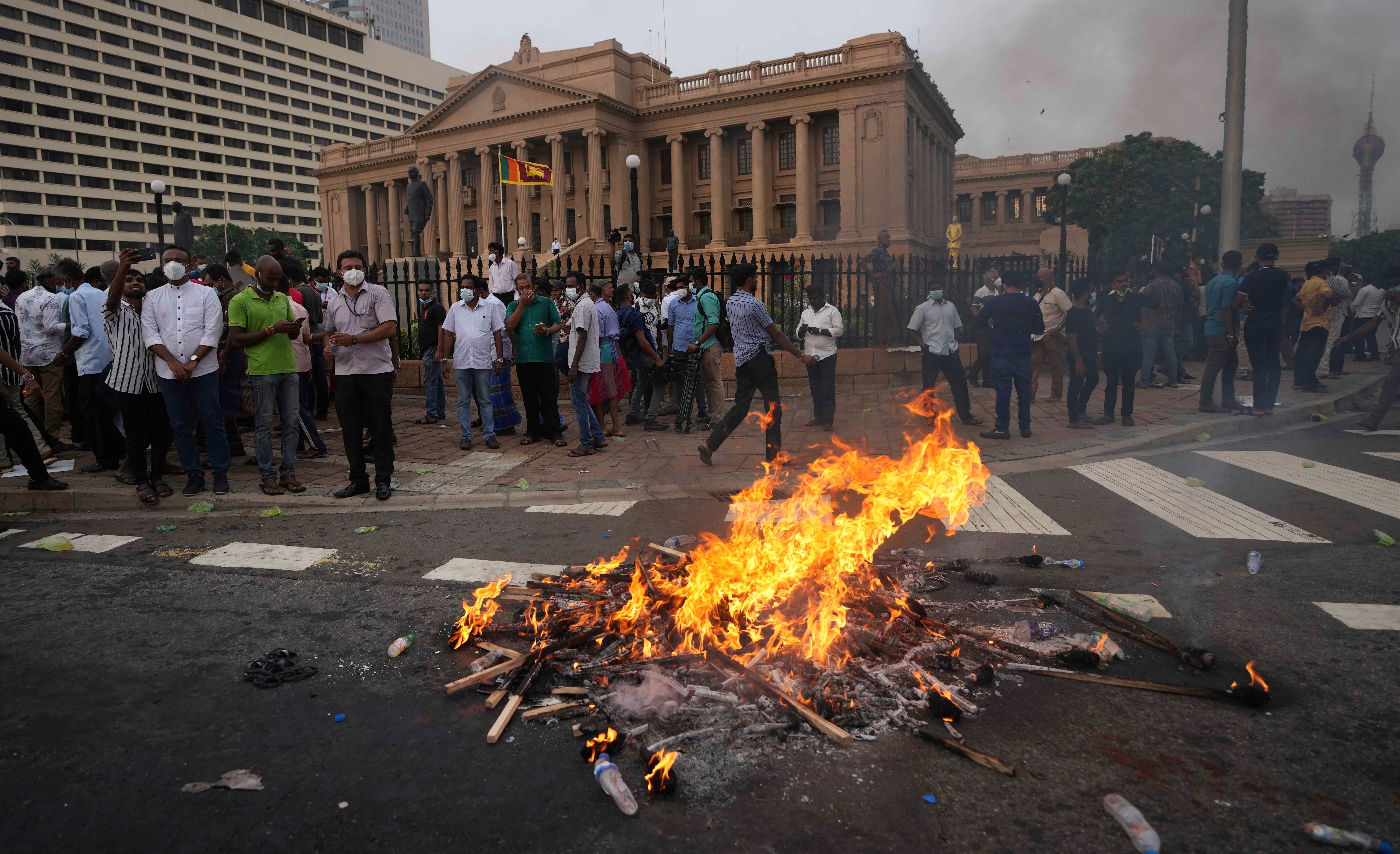 Anti-government demonstrators take part in a protest near the president’s office in Colombo