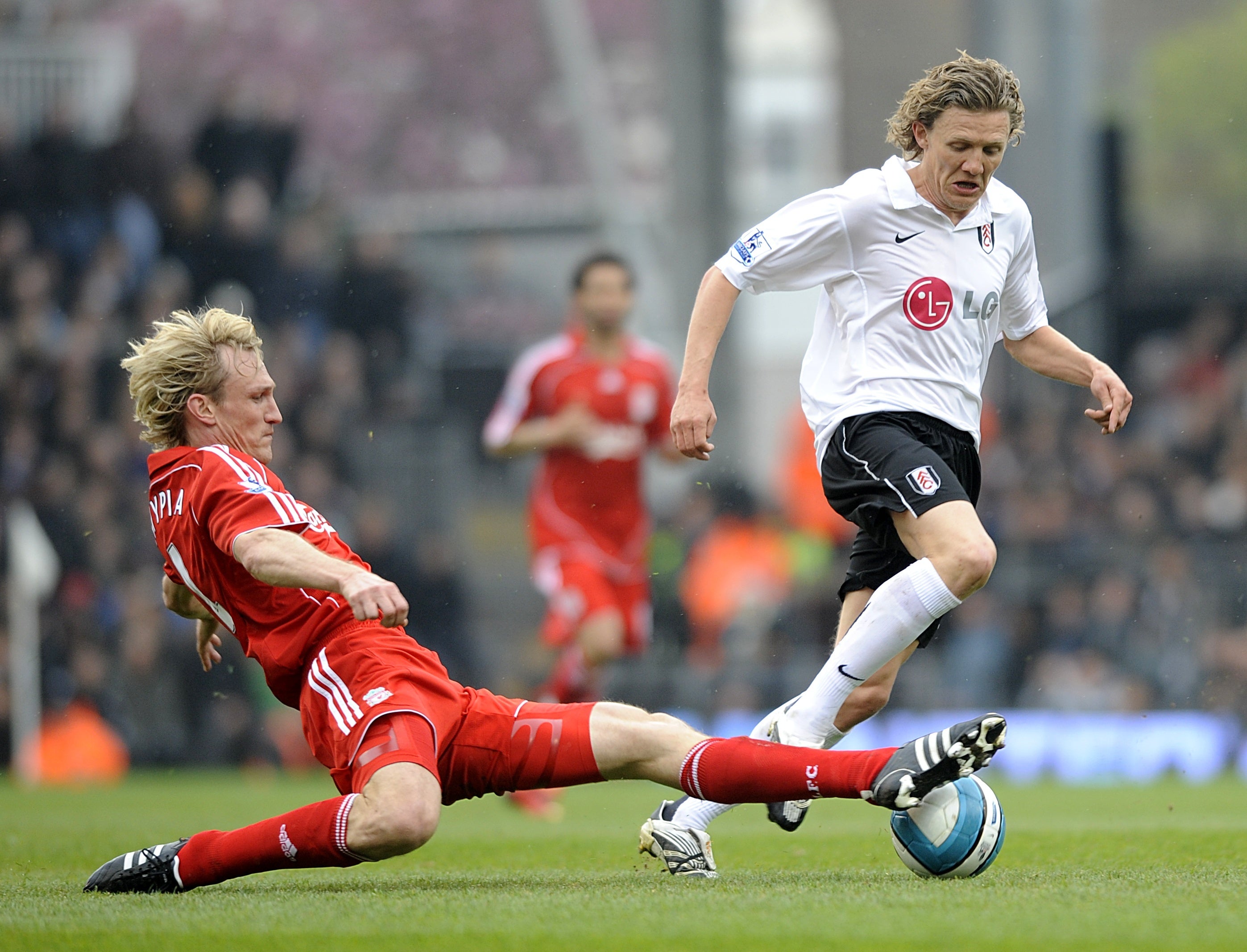 Fulham’s Jimmy Bullard (r) and Liverpool’s Sami Hyypia (l) battle for the ball (PA)