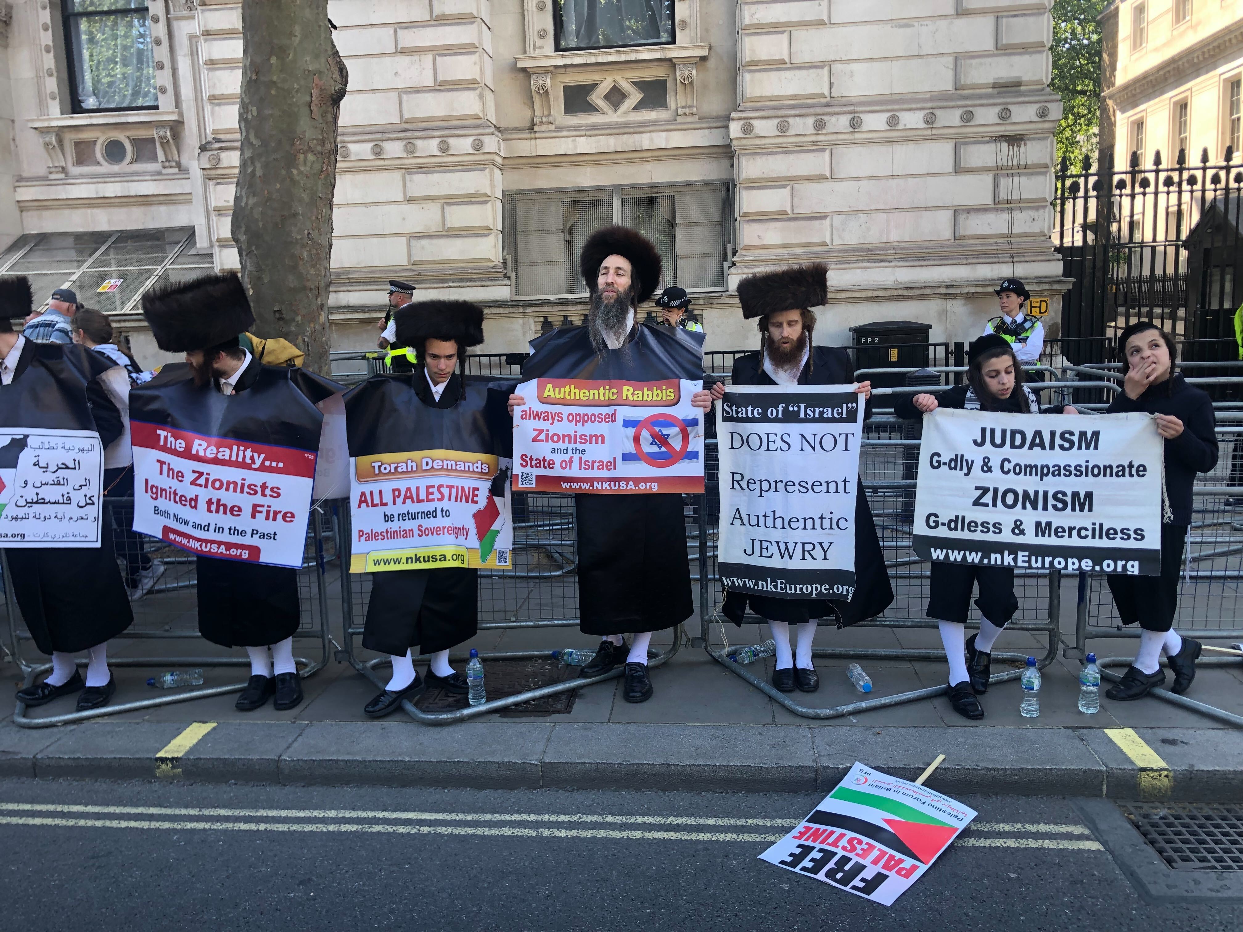 A group of protesters holding up signs at the rally in central London