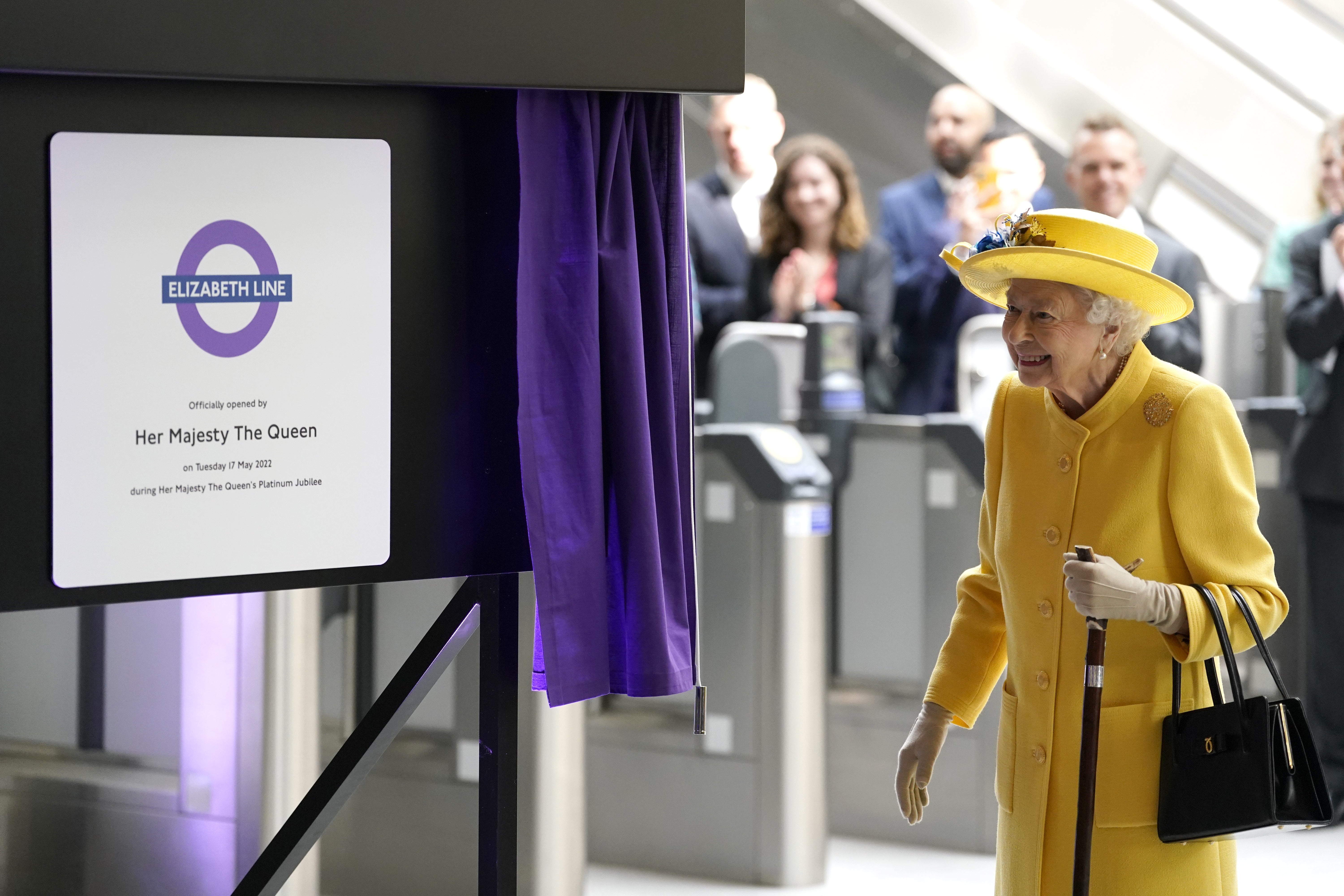 The Queen unveils a plaque to mark the Elizabeth line’s official opening at Paddington station (Andrew Matthews/PA)