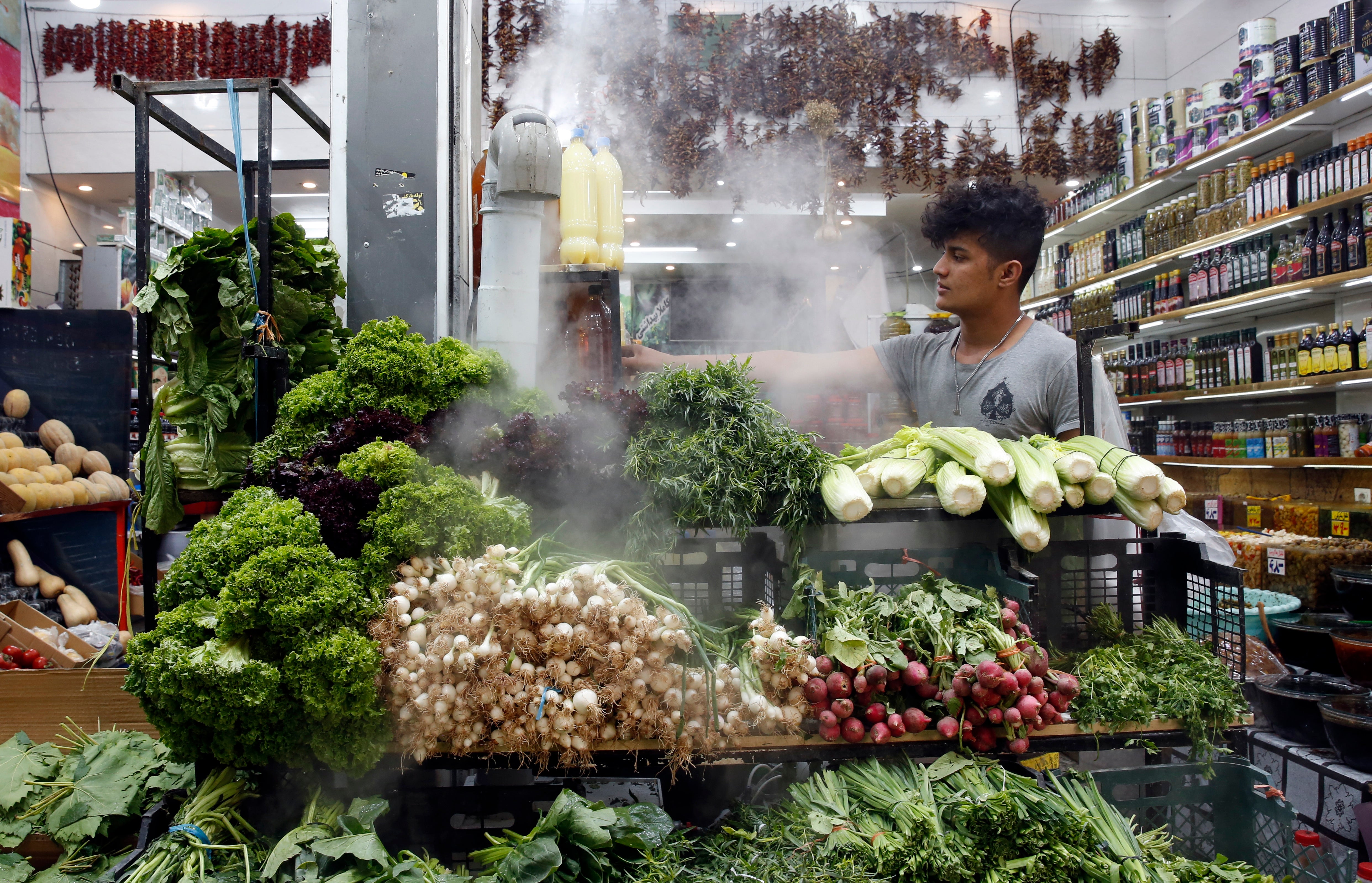 An Iranian seller works inside his shop in a street in Tehran earlier this month