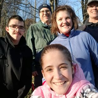 Alisa Campau (front) with her family. The Michigan family of the 17-year-old girl has sued the hospital that is denying Alisa placement on the kidney transplant list until she receives up to date vaccinations, as is required by the hospital’s policy