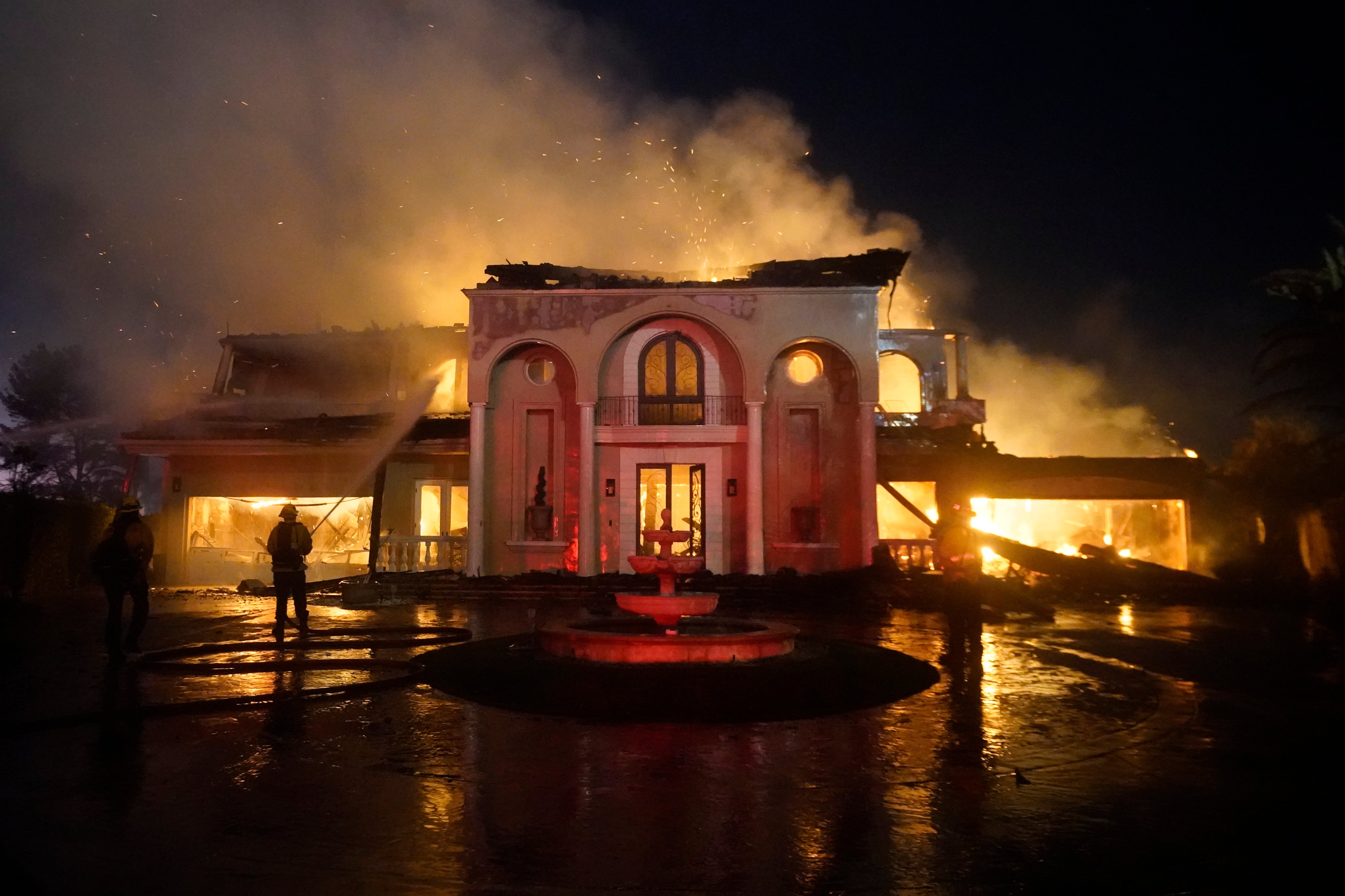 A home burns down during last week’s wildfire in Orange County, CA