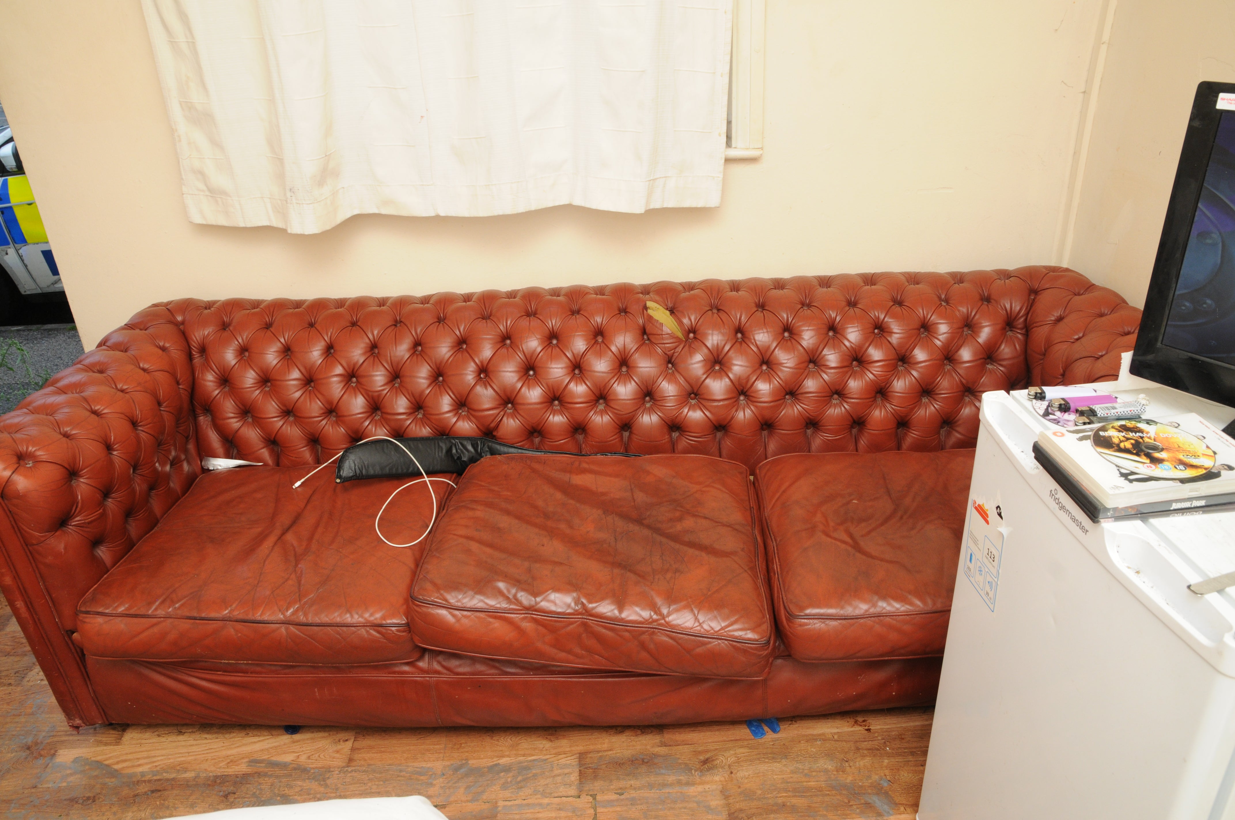 Searches of the hostel in Ipswich led to the nunchucks and a sword (seen here on the sofa) used to threaten the victim being recovered