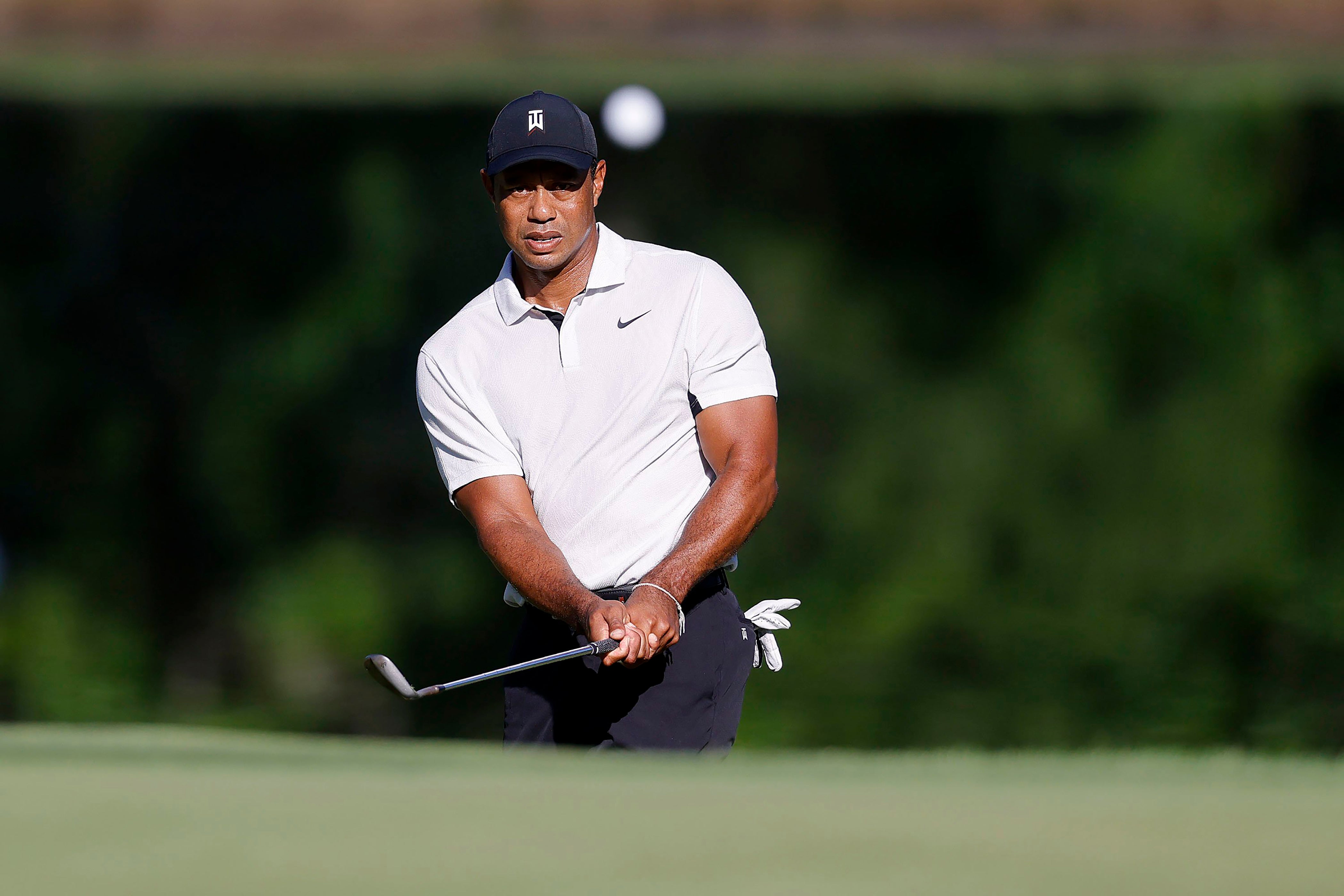 Tiger Woods hits a chip shot on the 11th hole during a practice round for the US PGA Championship (Mike Simons/Tulsa World via AP)