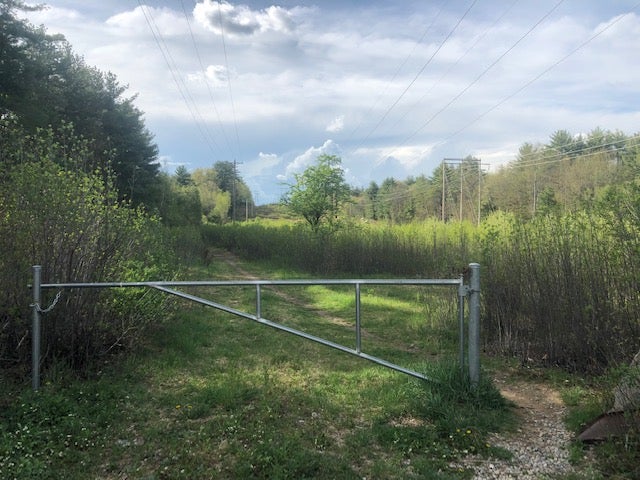 The Reids were found in a wooded area off Marsh Loop Trail, less than two miles from their Concord home; an entrance to the trail is pictured weeks after their deaths