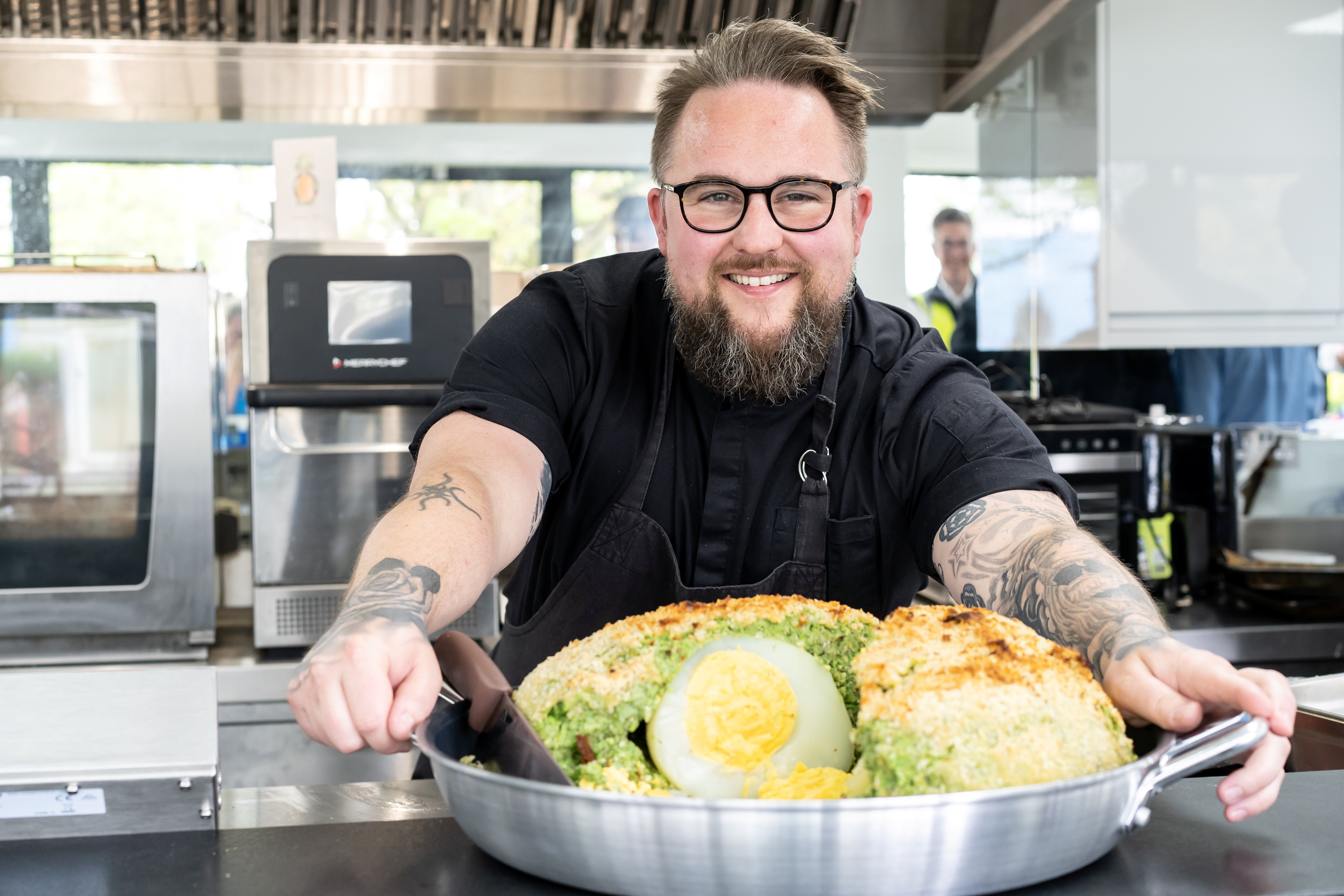 Leigh Evans poses with his gigantic vegetarian creation