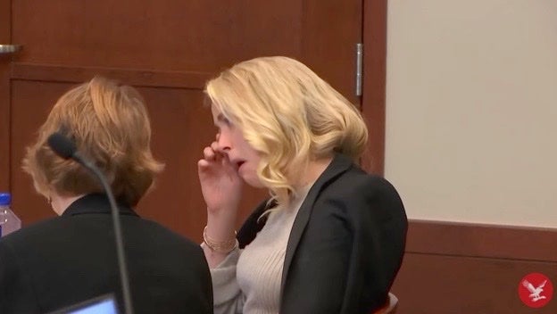 Amber Heard wipes away tears as she listens to Raquel Pennington’s testimony