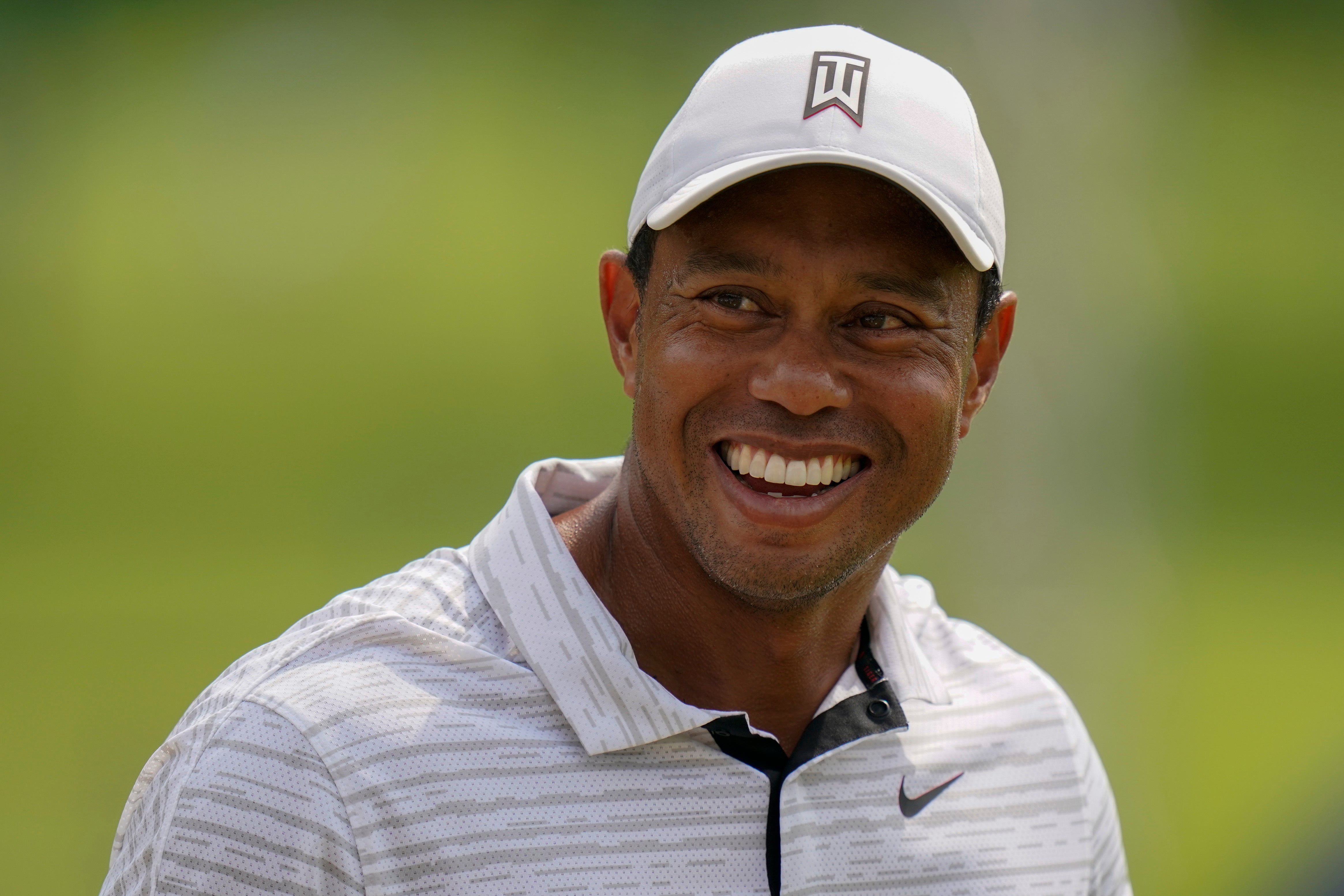 Tiger Woods smiles on the driving range before a practice round for the US PGA Championship (Eric Gay/AP)