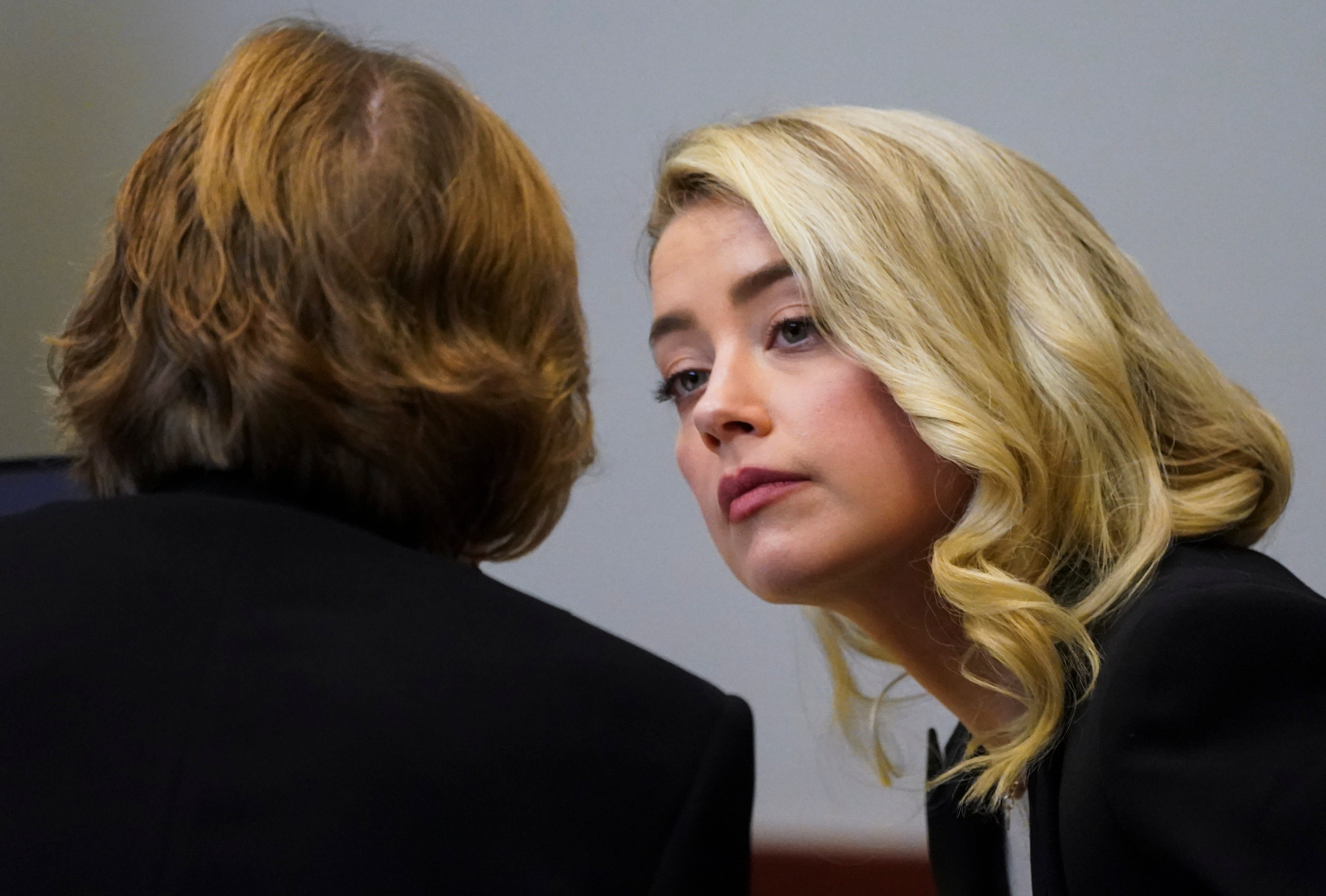 Actor Amber Heard (R) talks with her lawyer Elaine Bredehoft during a defamation case against her by ex-husband, actor Johnny Depp, at the Fairfax County Circuit Courthouse in Fairfax, Virginia, USA, 18 May 2022