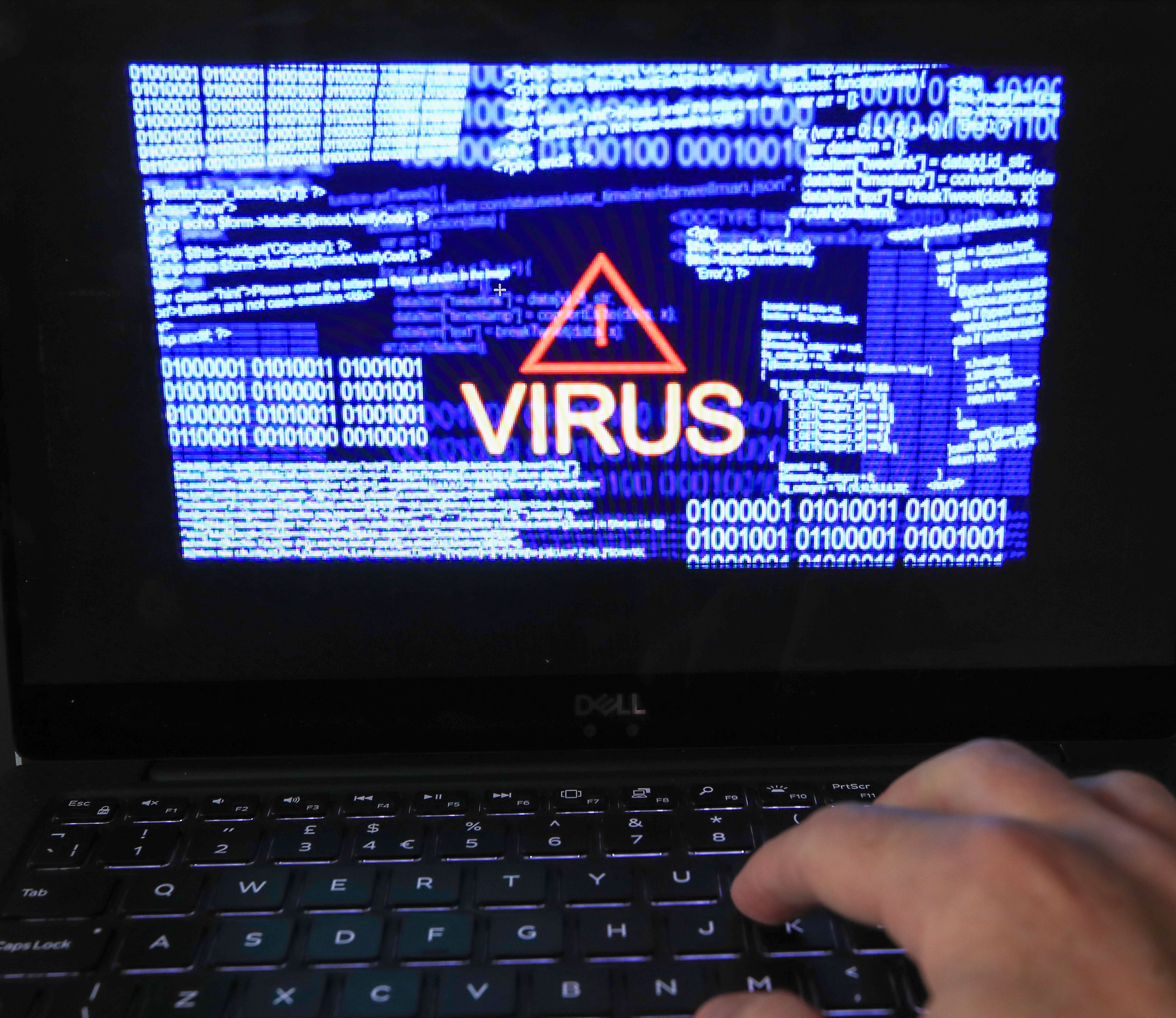 A laptop screen showing a computer virus warning (PA)