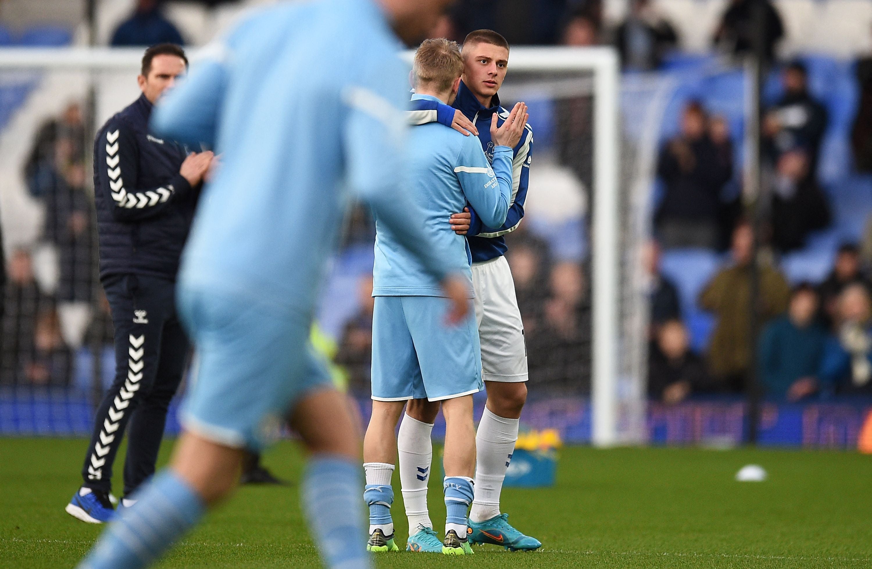 Manchester City's Ukrainian midfielder Oleksandr Zinchenko, left, embraces Everton's Ukrainian defender Vitaliy Mykolenko