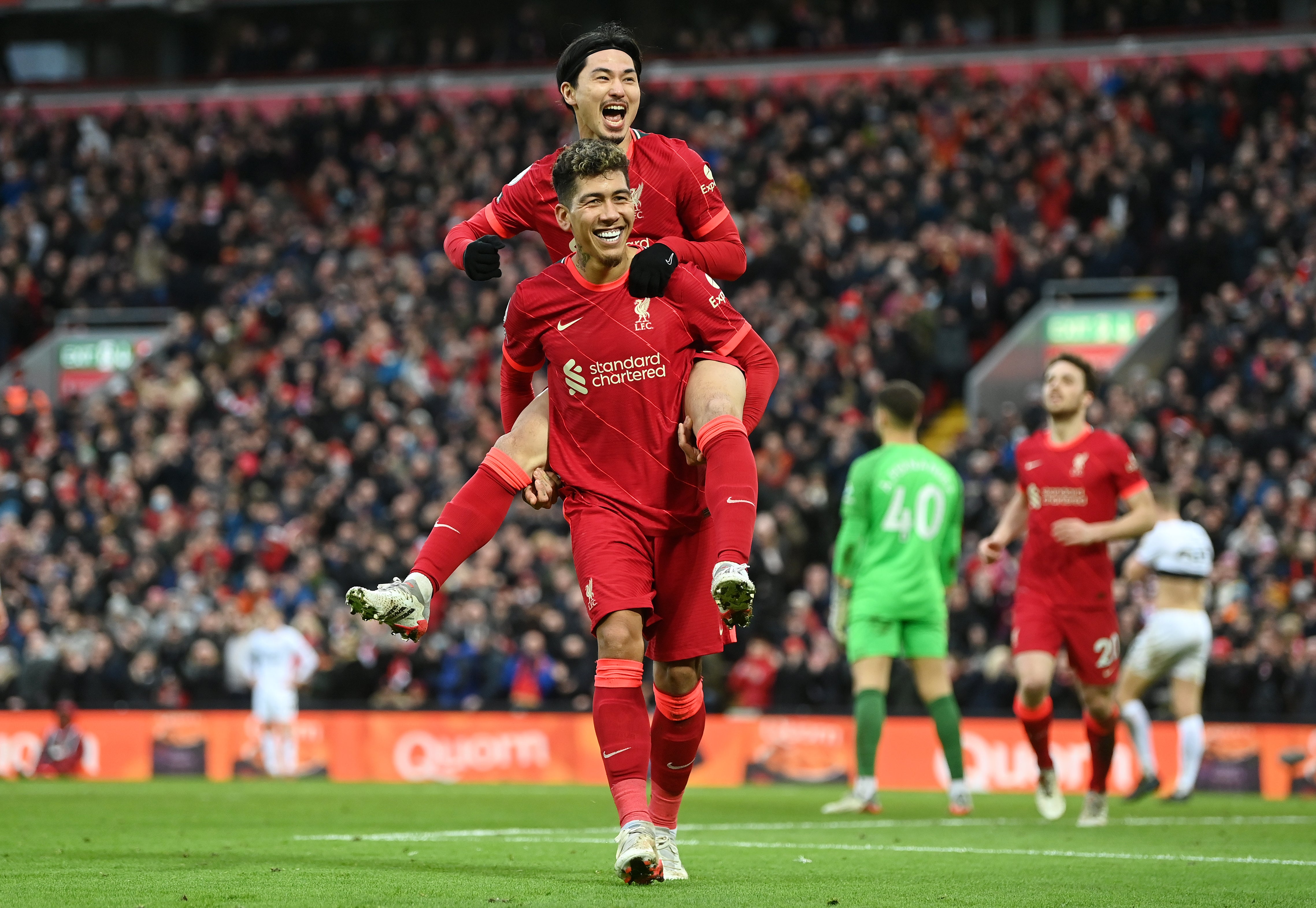 Takumi Minamino of Liverpool celebrates with Roberto Firmino after scoring against Brentford in January