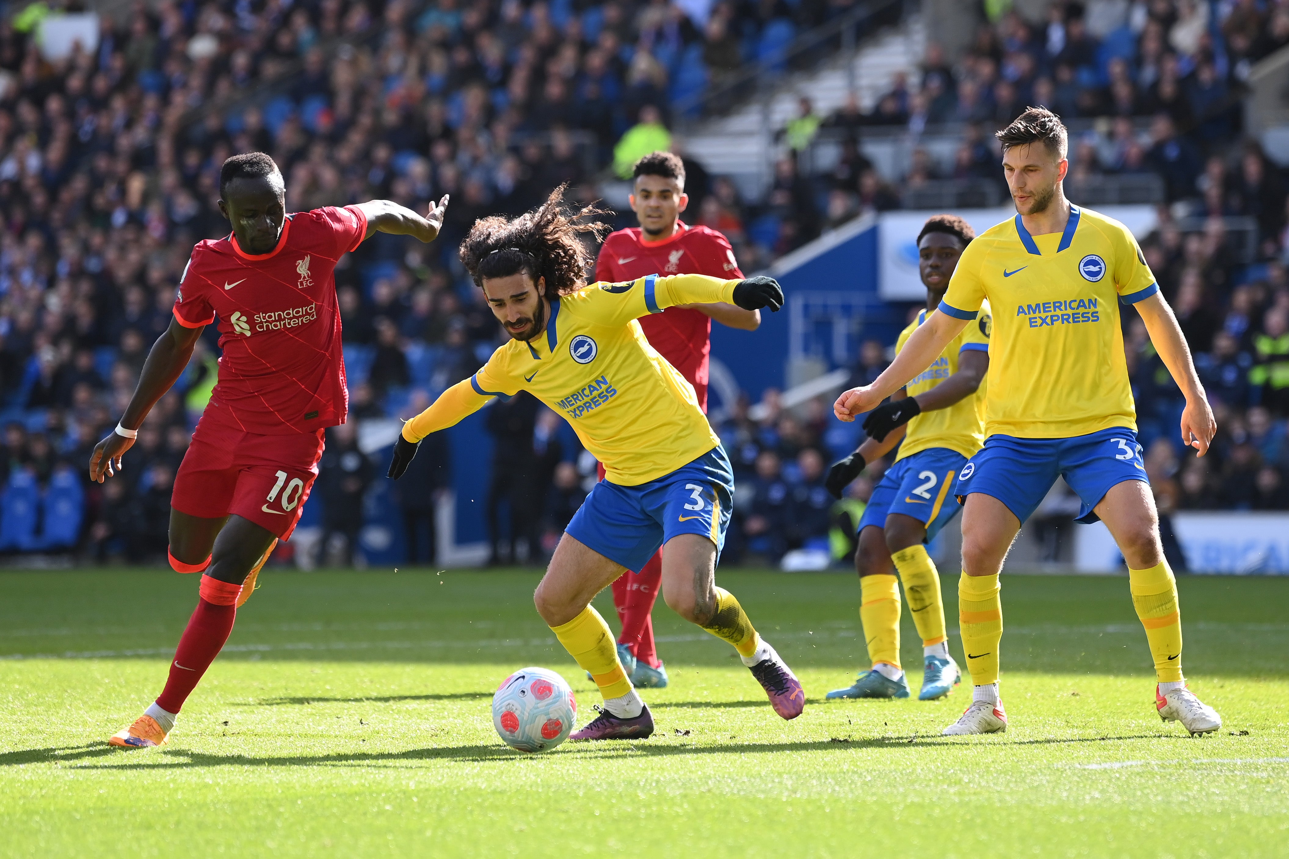 Marc Cucurella of Brighton & Hove Albion is challenged by Sadio Mane of Liverpool during a match in March