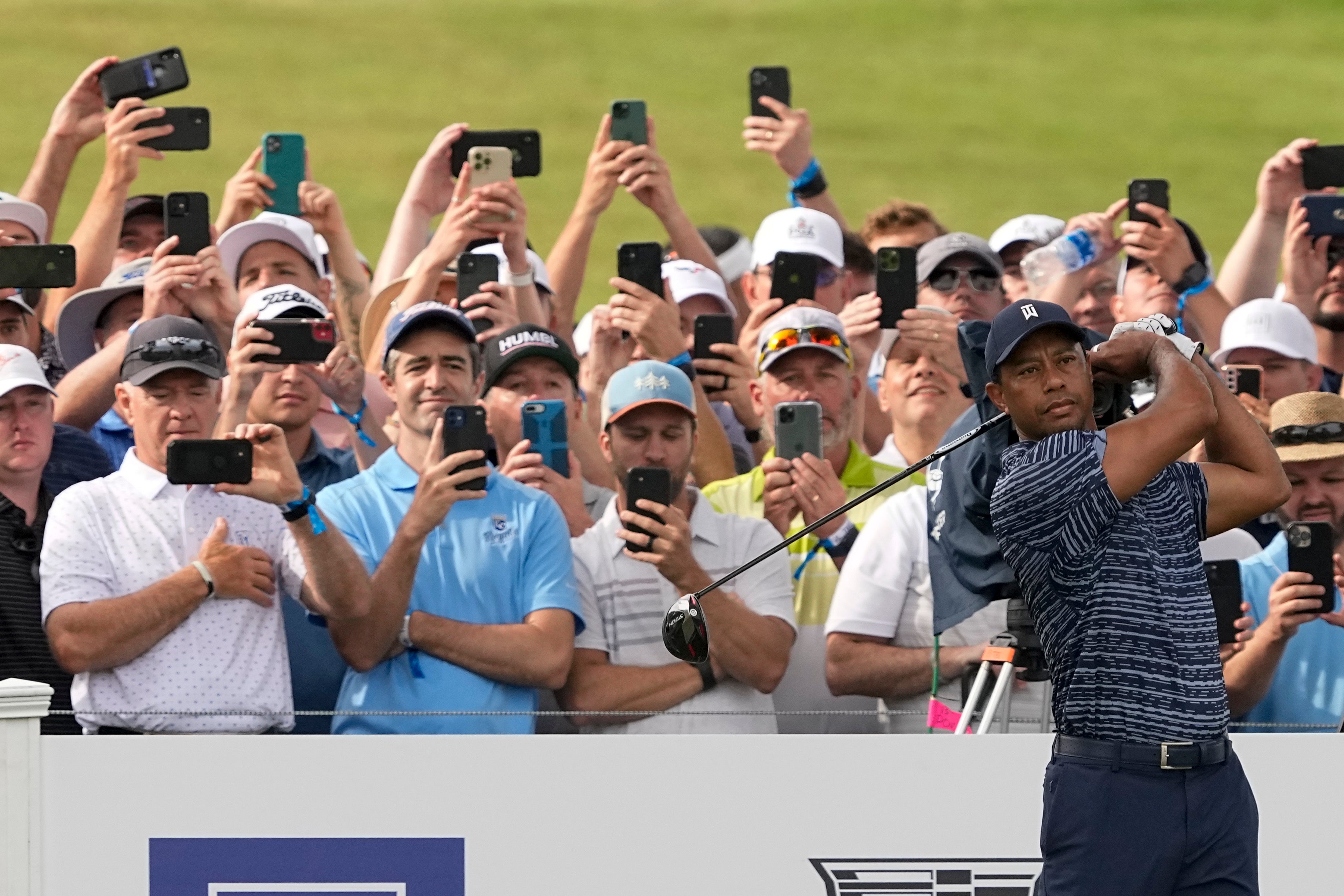 Tiger Woods hits his tee shot on the 13th hole during the first round of the US PGA Championship (Matt York/AP)