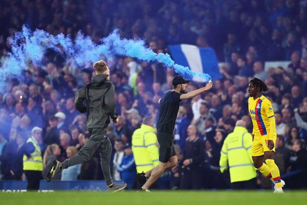 An Everton fan invades the pitch