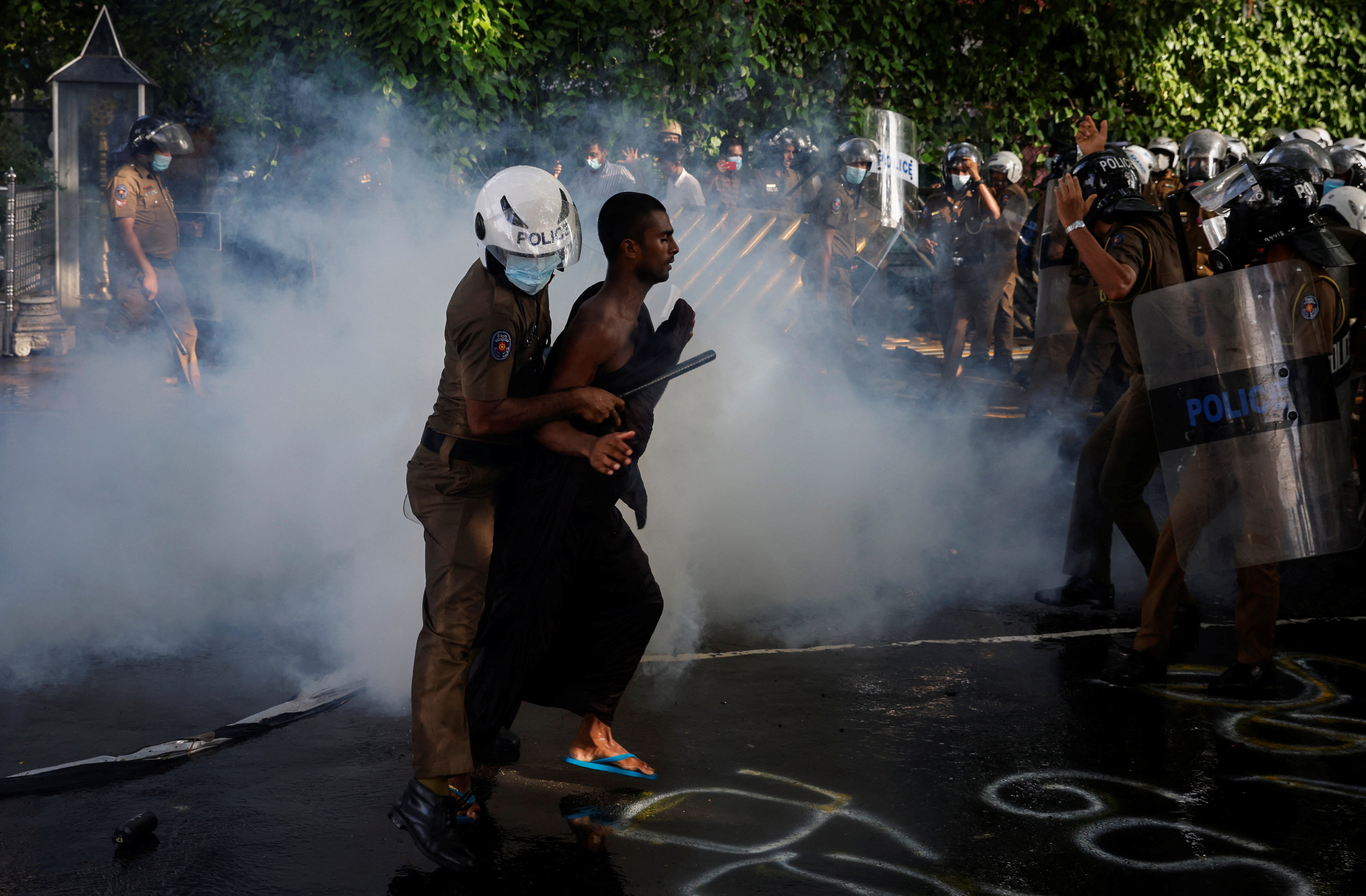 Police use tear gas to disperse demonstrators during a protest organised by students near the President's House