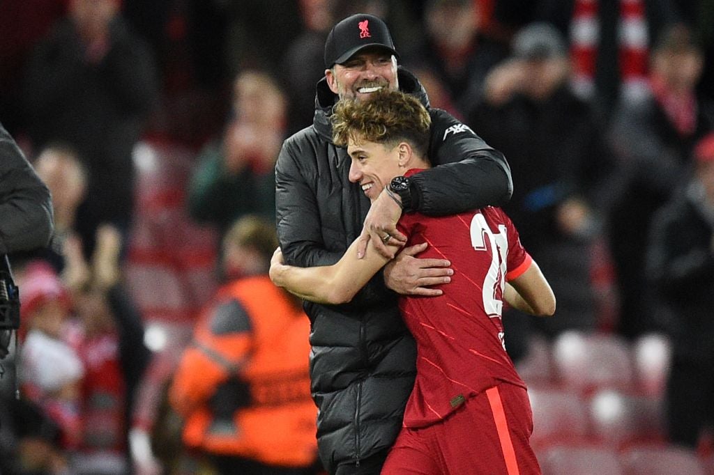 Defender Kostas Tsimikas receives a hug from Klopp after a Champions League match