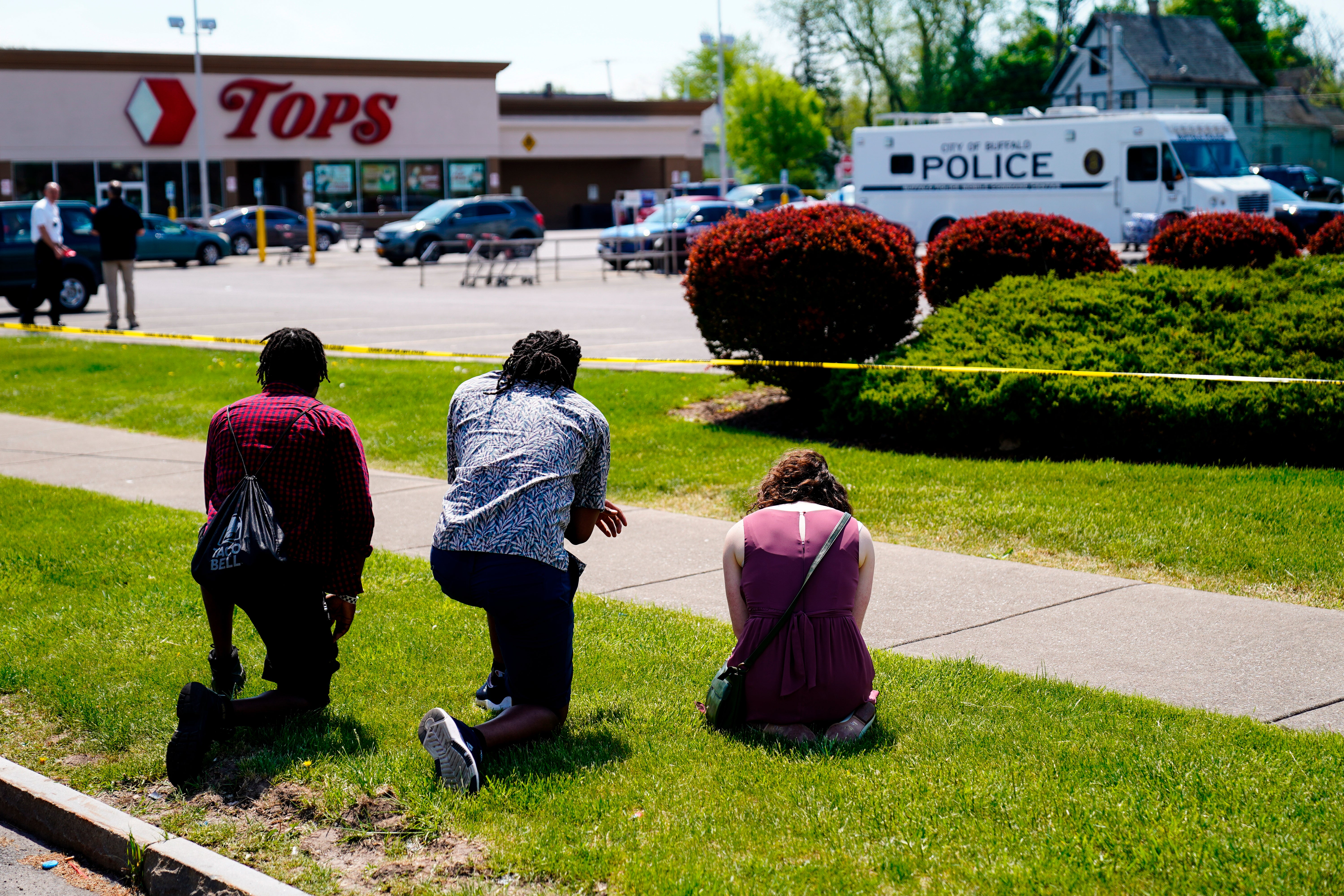 People pray outside the Tops Friendly Market in Buffalo, New York