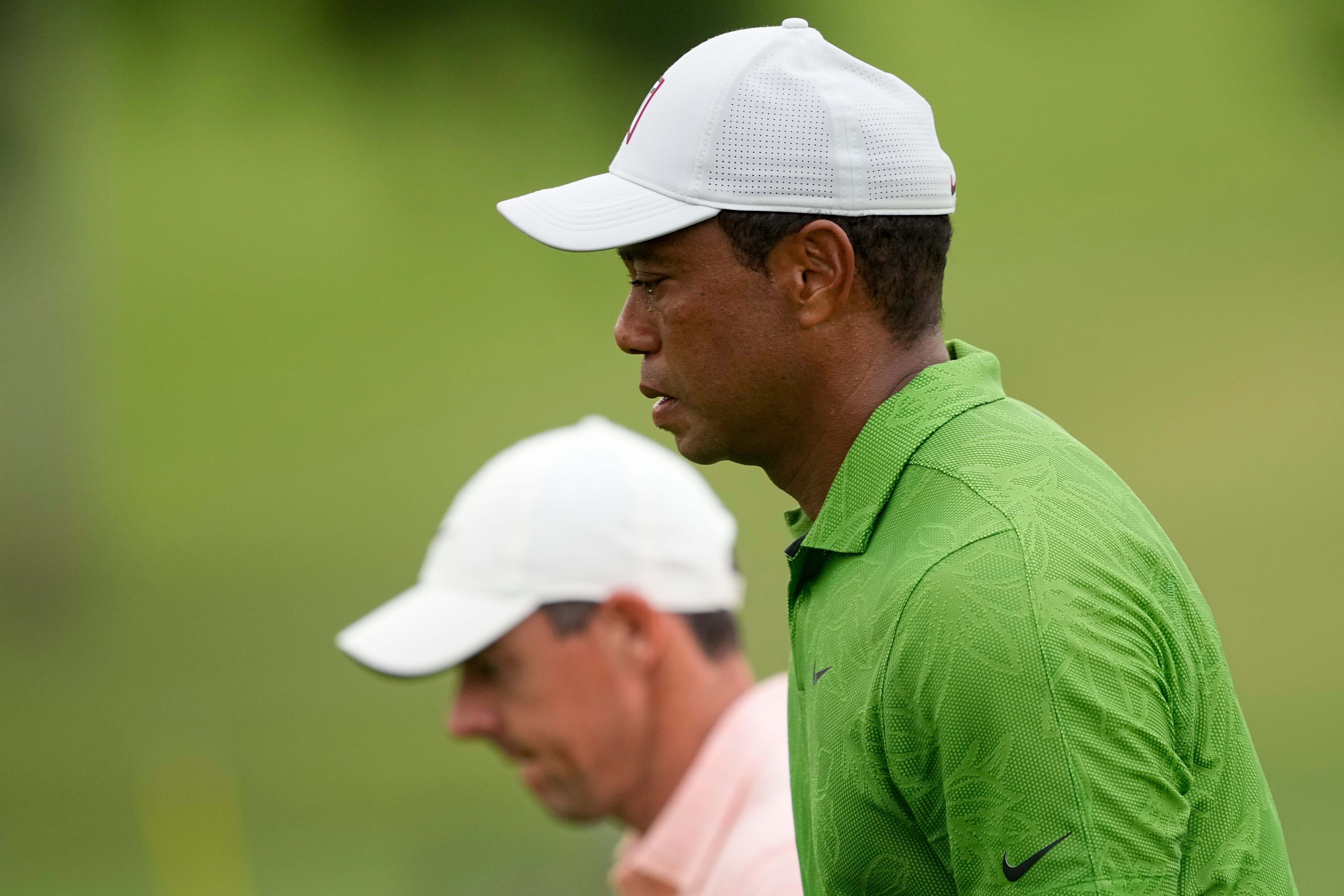 Rory McIlroy (background) hailed Tiger Woods as the “ultimate pro” after he made the cut in the US PGA Championship (Matt York/AP)