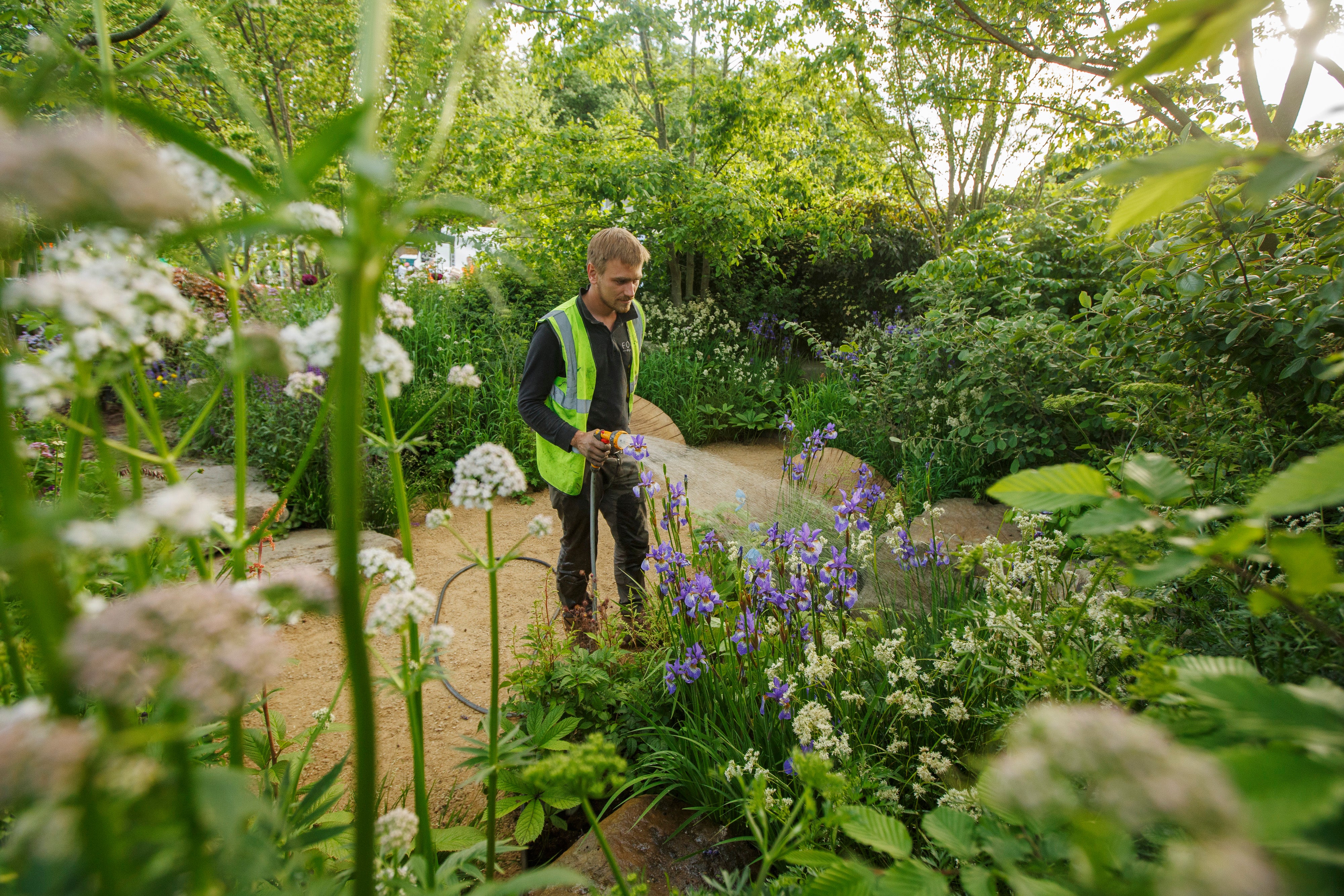 Garden designer Jamie Butterworth waters his sanctuary garden, ‘The Place2Be Securing Tomorrow Garden’ during the build-up to the RHS Chelsea Flower Show (RHS/Luke MacGregor/PA)