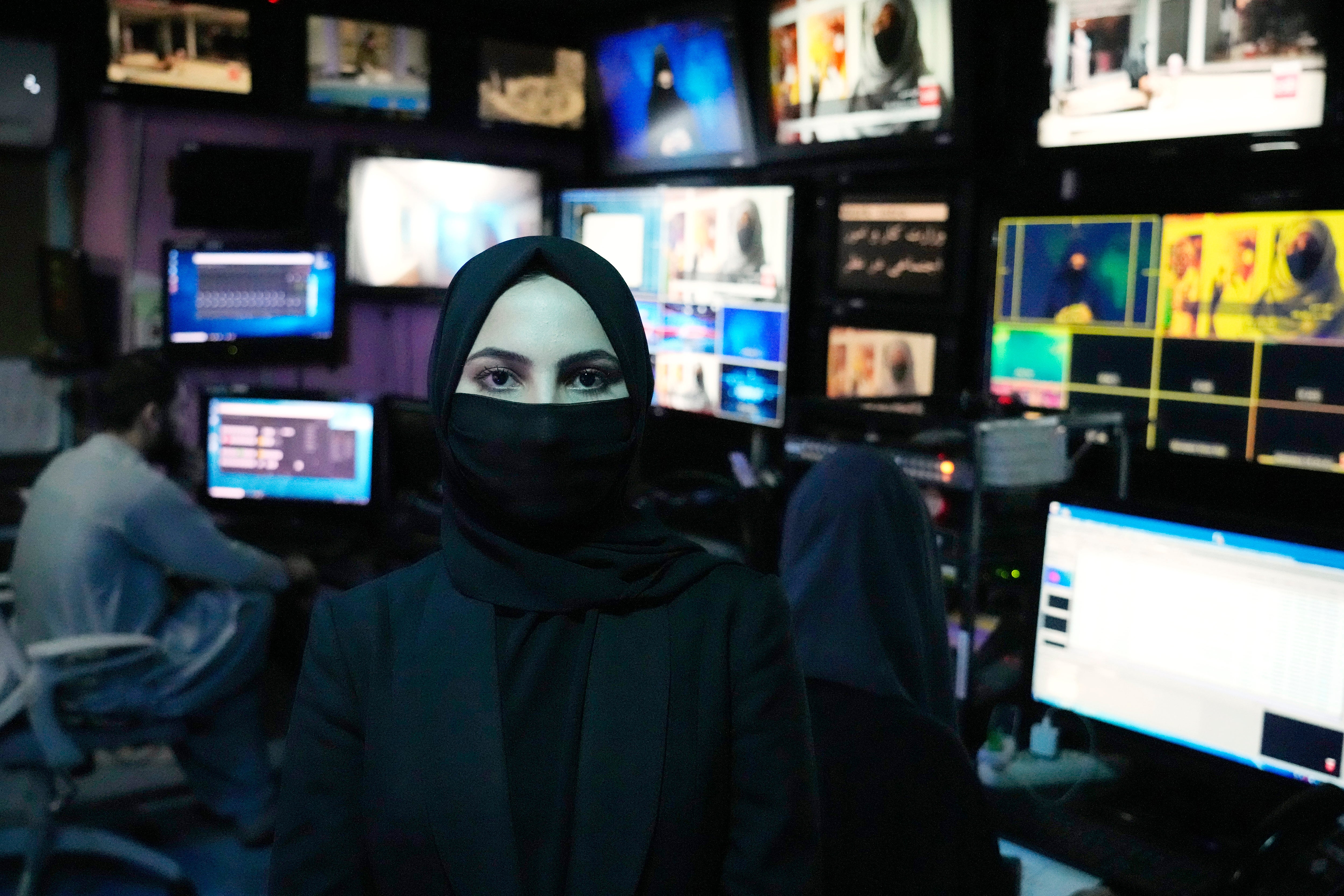 Sonia Niazi a TV anchor works in a TOLO NEWS studio while covering her face, in Kabul, Afghanistan.